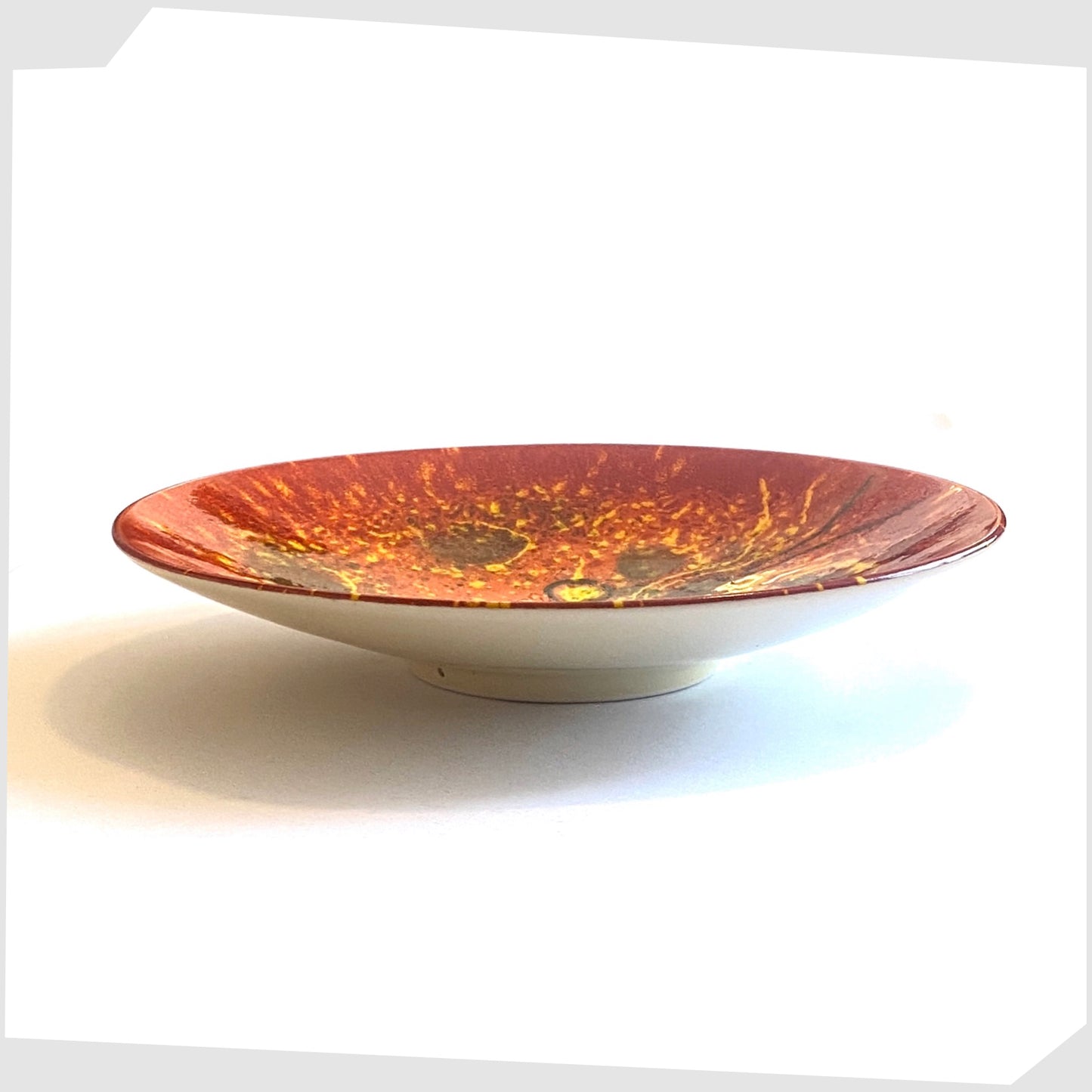 conical shape of the poole pottery alignment of the planets venus plate glazed in fiery red and orange with yellow spheres