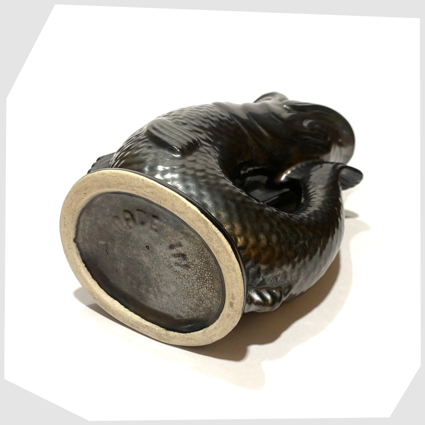 base of the vintage dartmouth pottery gluggle jug in matte black glaze