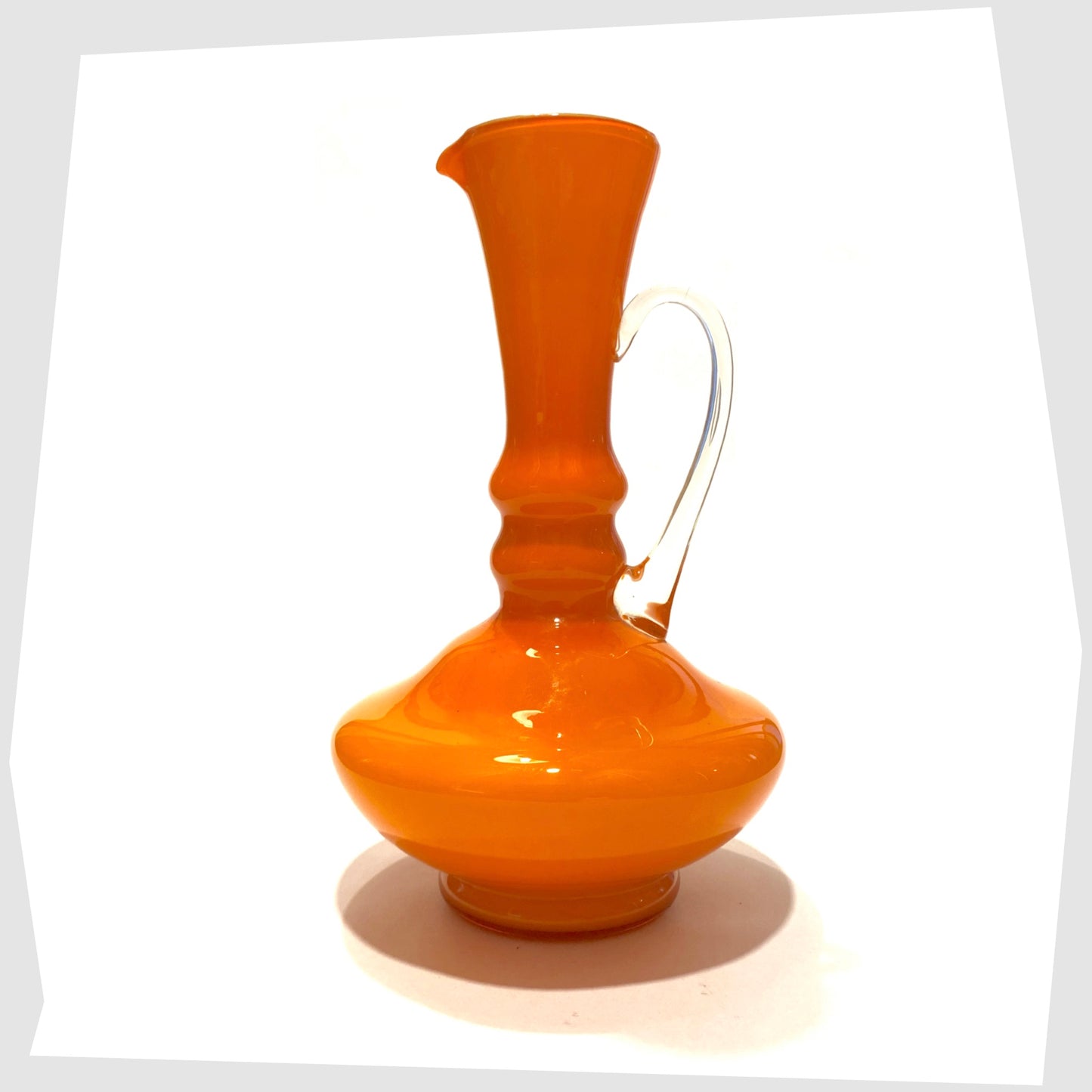 vintage empoli glass jug in orange cased glass with clear glass handle