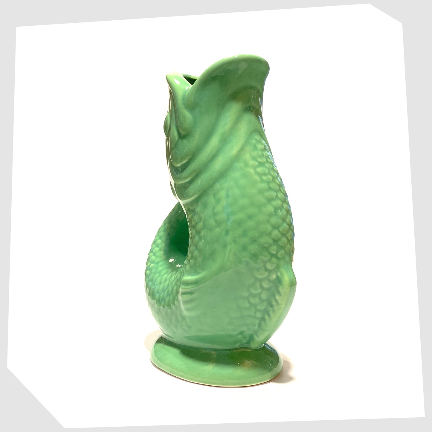 front of the Ceramic Fish-Shaped Vase in bold green glaze