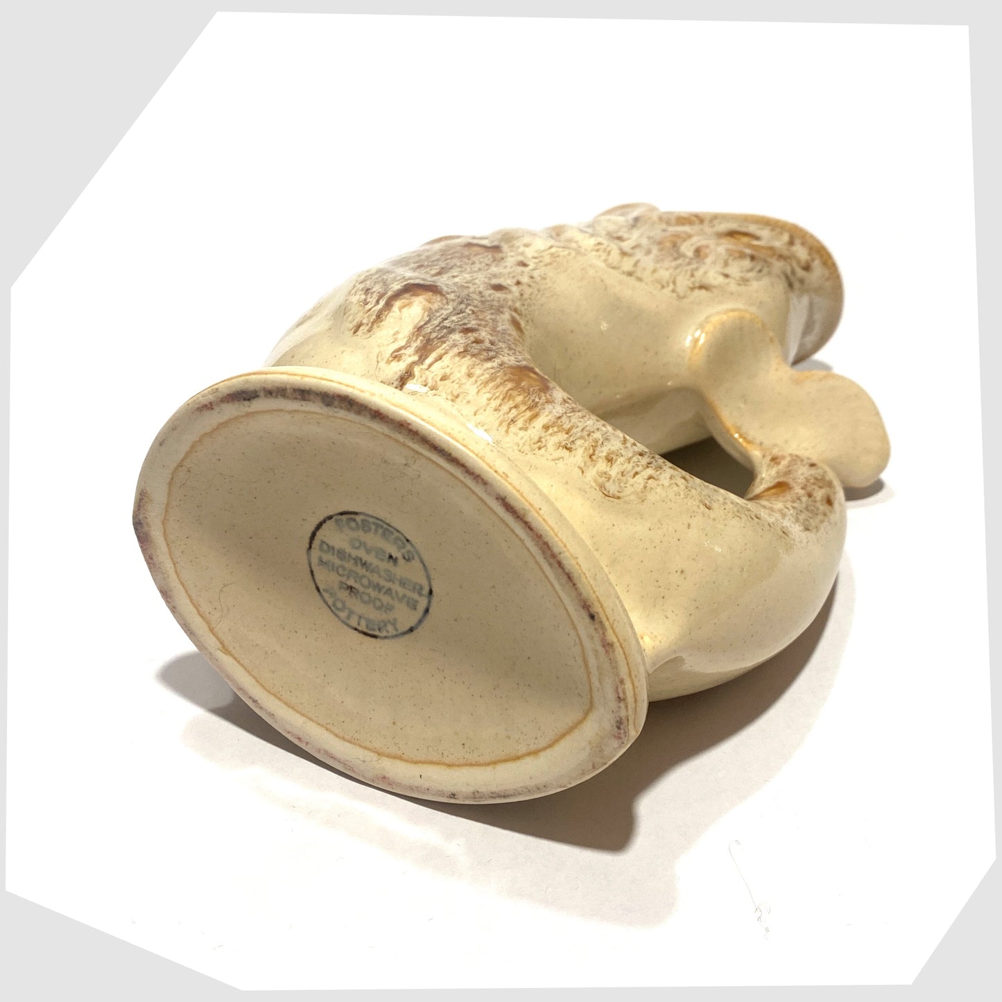 base of the vintage Fosters Studio Pottery Gluggle Jug in a beige and amber honeycomb drip glaze