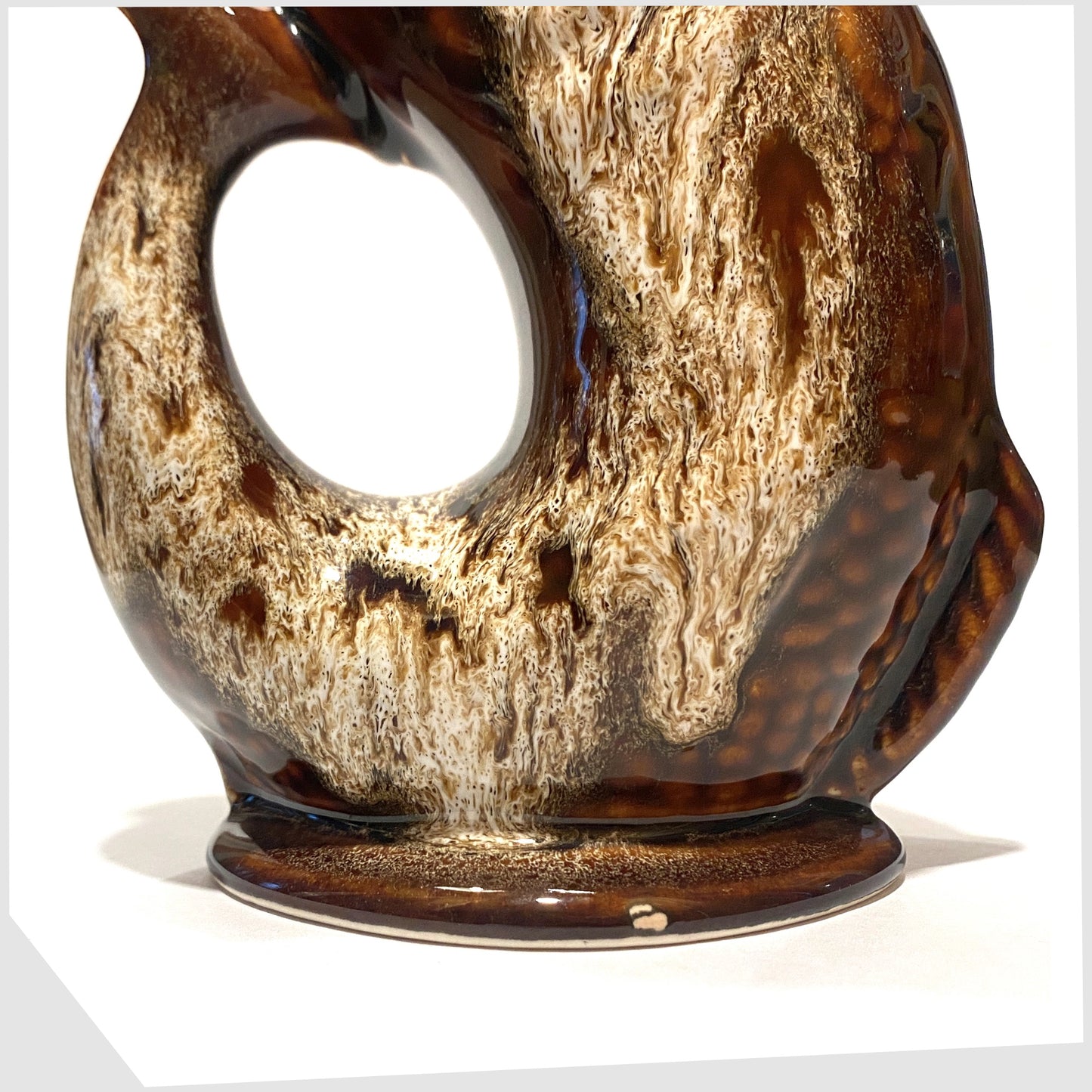 close up of the vintage fosters studio pottery fish-shaped gluggle jug in chestnut brown drip glaze