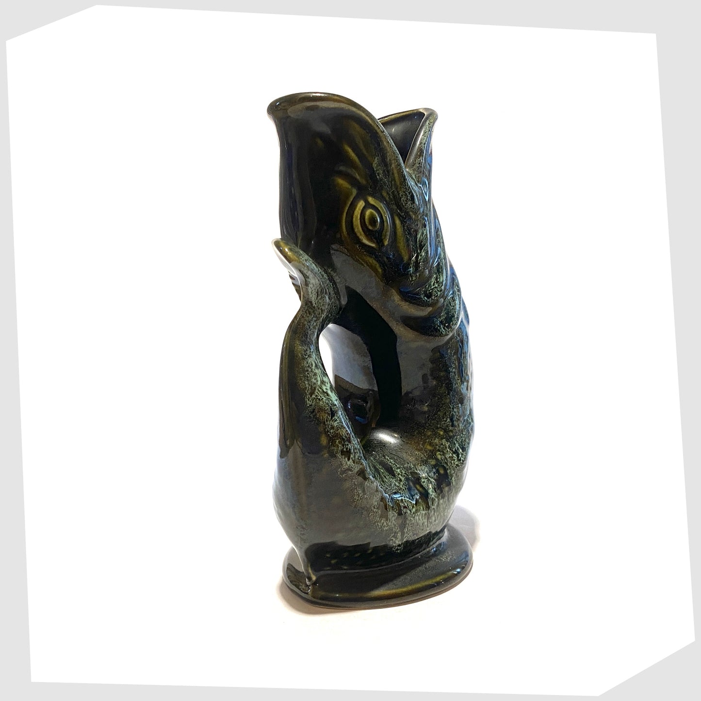 tail of the vintage fosters studio pottery gluggle jug in green honeycomb glaze