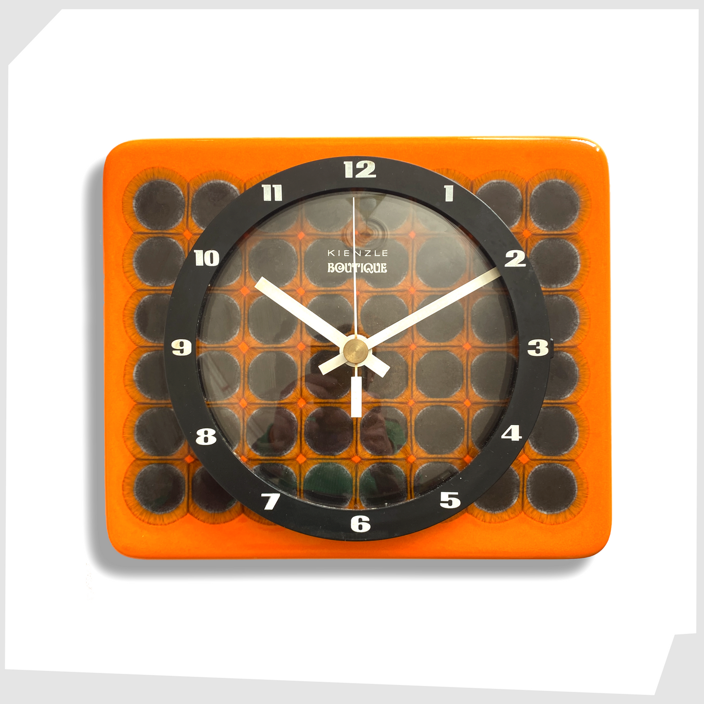 kienzle boutique ceramic wall clock in vivid orange glaze with geometric circular pattern, with white hands
