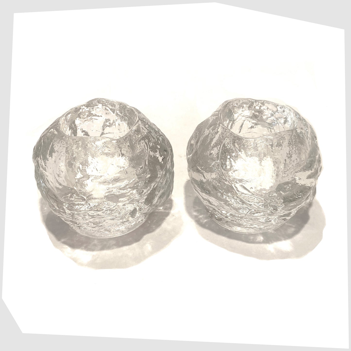 top of the Pair of Kosta Boda Snowball Tealight holders, made in clear textured glass