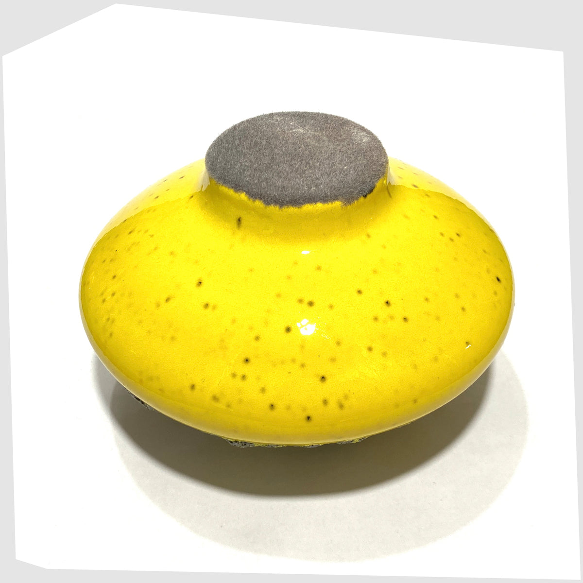 Felted base of the Otto Keramik Vase, model 203, in vibrant yellow glaze with grey fat lava, shown on a white background