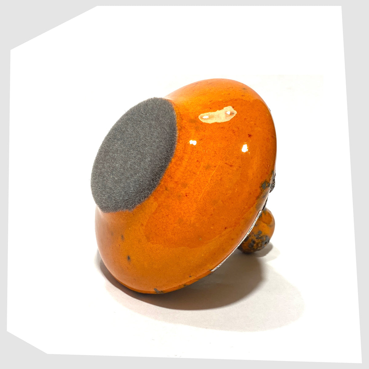 Felted base of the Otto Keramik 206s Vase in a vibrant orange glaze with grey fat lava, shown on a white background
