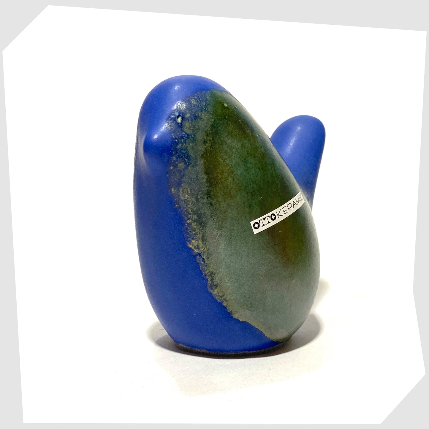 otto keramik bird ornament in matte blue glaze with sea green circle