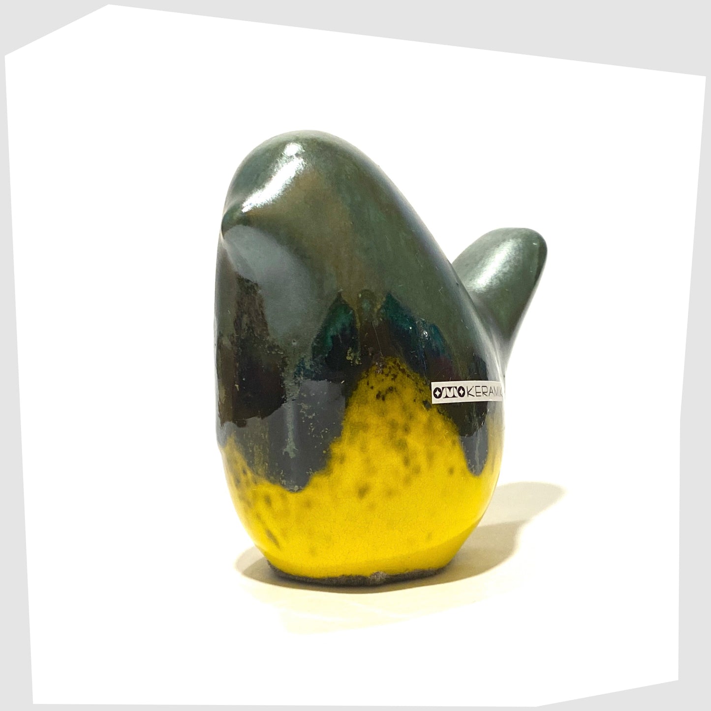ceramic bird in sea green drip glaze over a gloss yellow base, made by otto keramik, Germany
