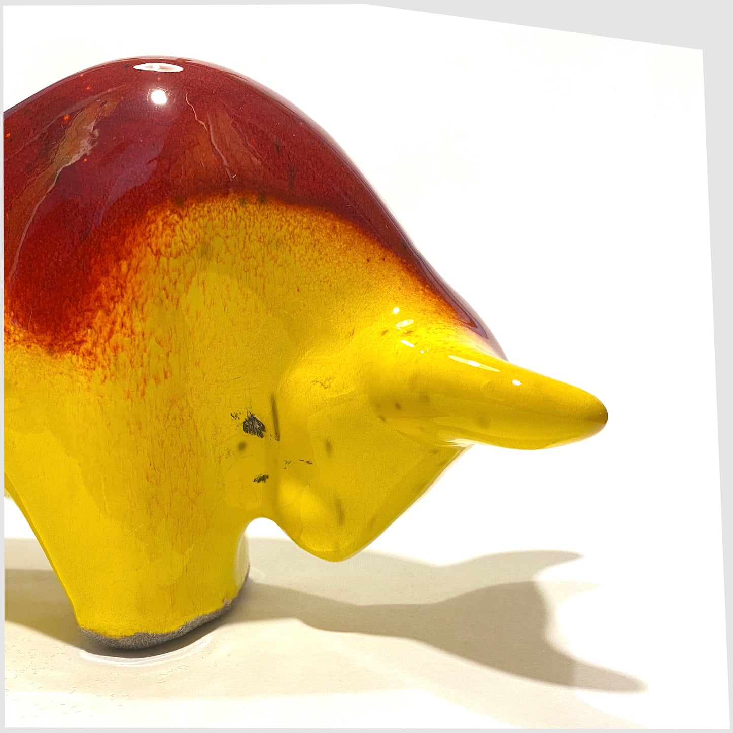 inner neck area of the otto keramik bull in red over yellow glaze