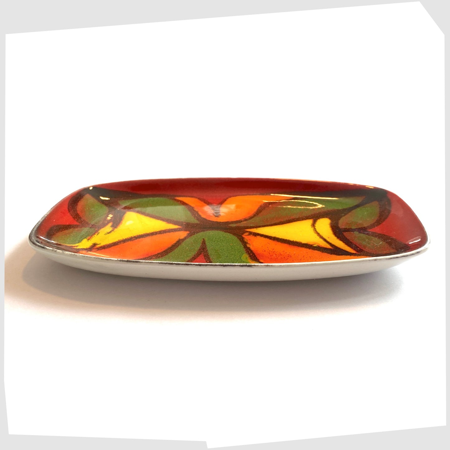 decorative dish, shape 361, by poole pottery, glazed in the delphis pattern in vibrant red, green, yellow and orange