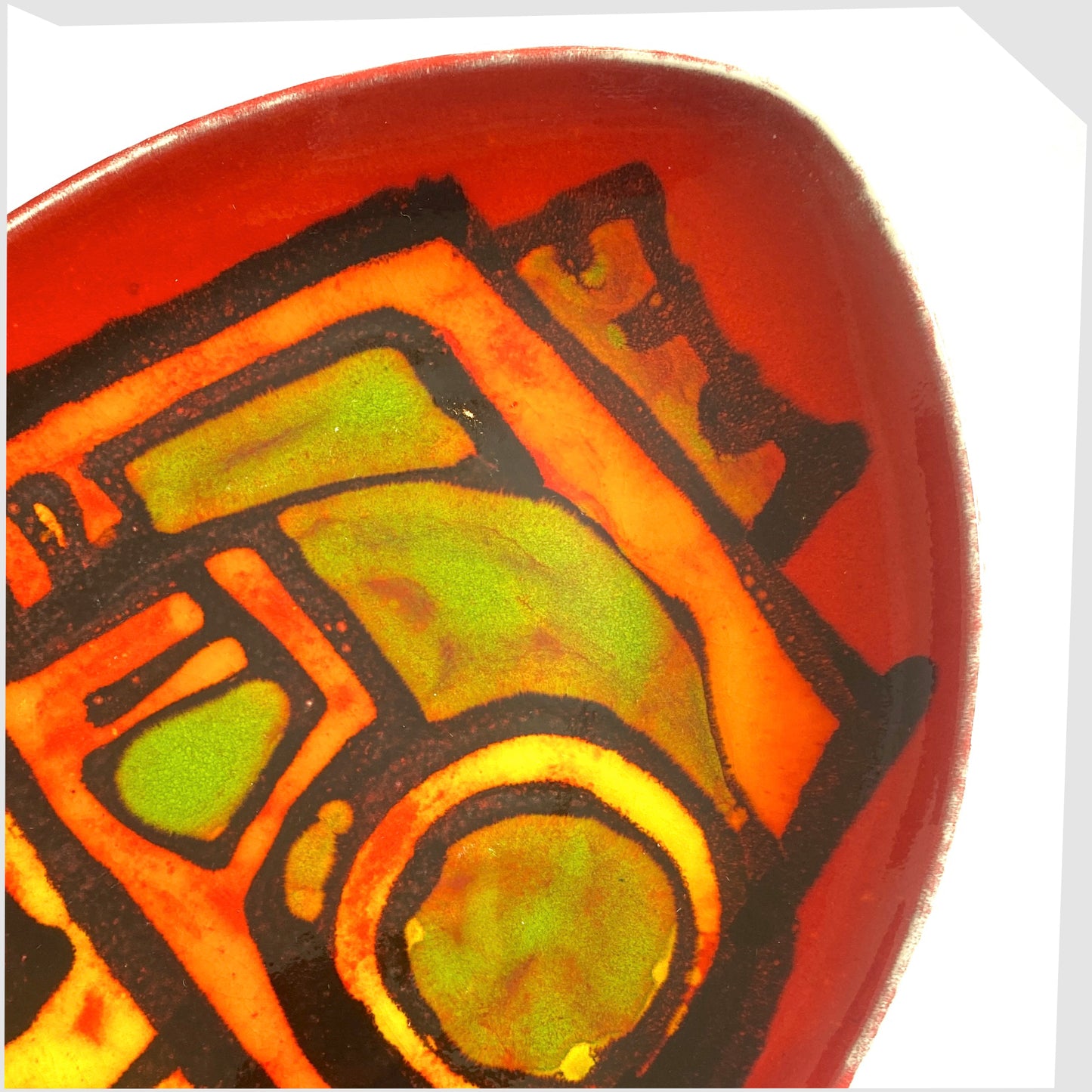 red delphis glazing on the poole pottery delphis teardrop dish, shape 91, designed by Carol Cutler.