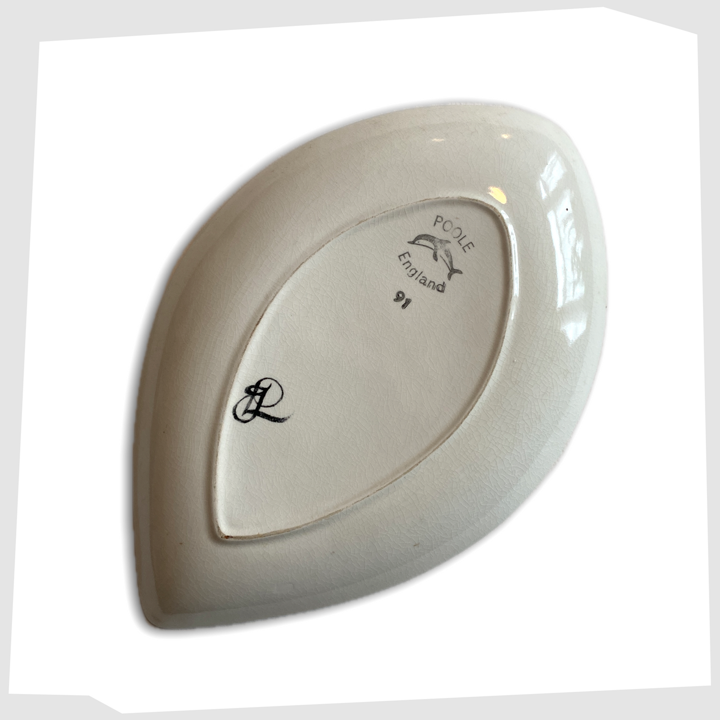 rear of the Poole Pottery Delphis Teardrop dish in vivid red and yellow glaze, created by Janet Laird