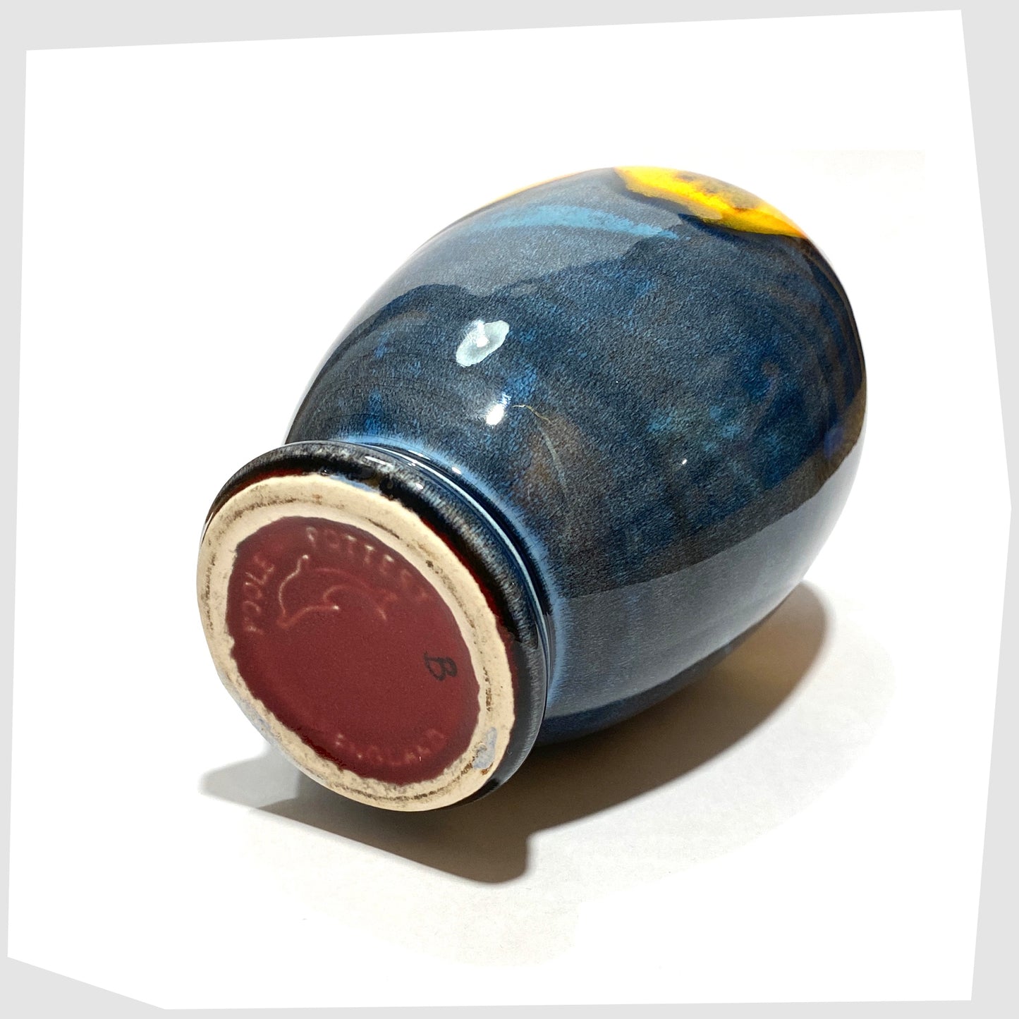 base of the Poole Pottery Wild Poppy Vase in a marbled blue glaze with vivid yellow wild poppy flower