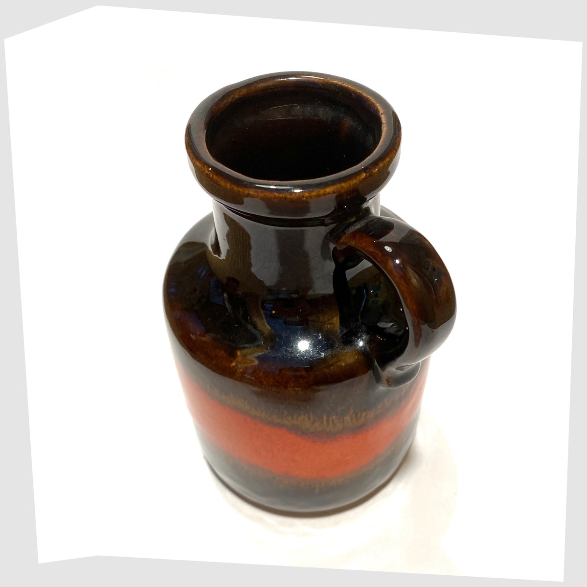 Top rim of the West German Pottery Scheurich Keramik 414-16 Vase in chestnut brown glaze with a central band of volcanic red, shown on a white background