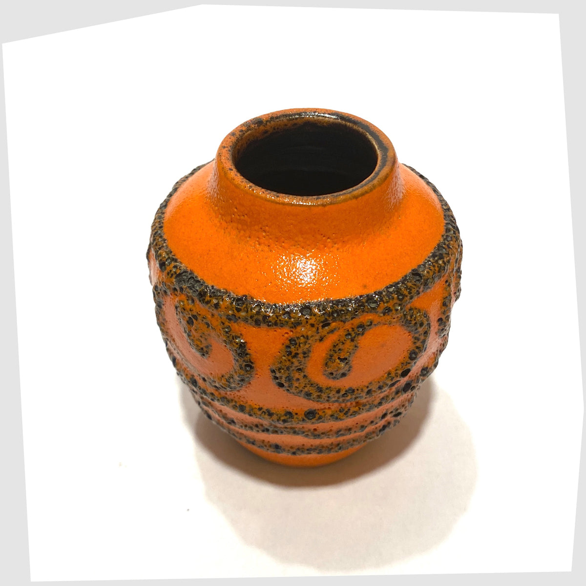 Top view of the Scheurich Keramik 550-10 Vase in vibrant orange glaze with deep fat lava swirls and flowing lines, shown on a white background