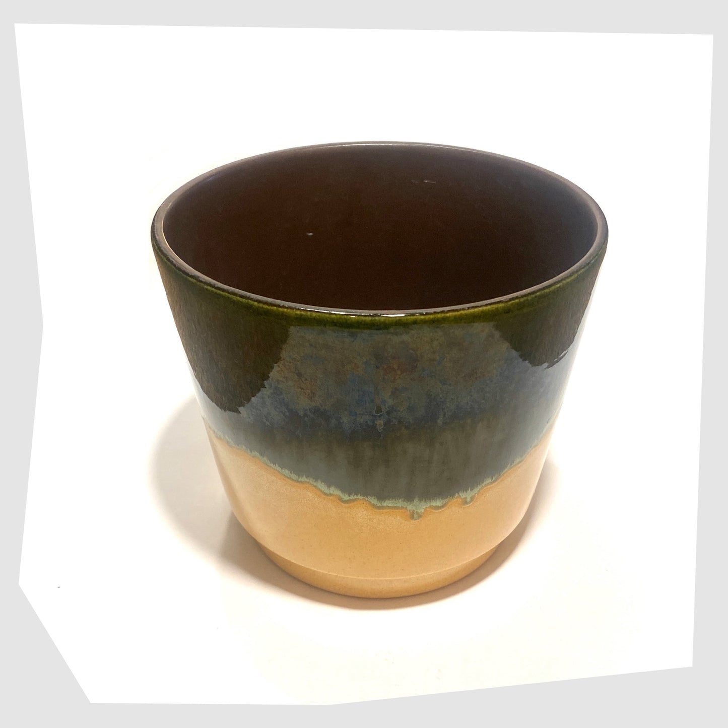 Top rim and inner glaze of the Scheurich Keramik 806-19 Planter in dark green and compliment beige glaze, shown on a white background