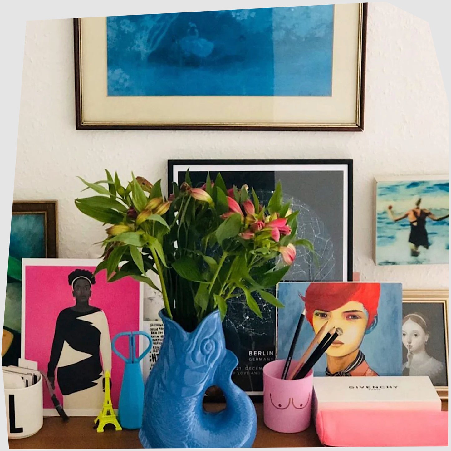 XL sea blue gluggle jug displayed with flowers