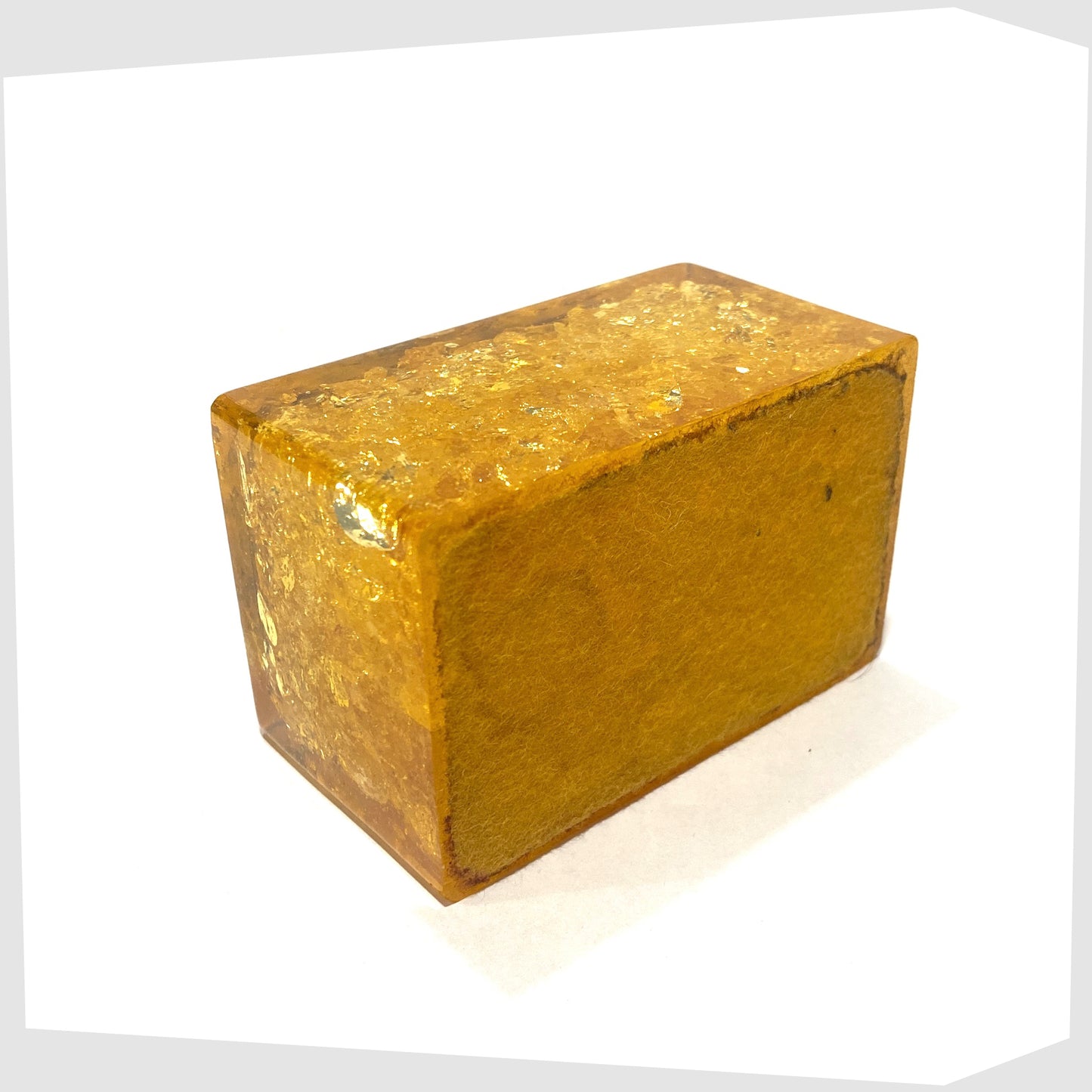 felted base of the Orange Shattaine Table Lighter in rectangular resin with brass fitting