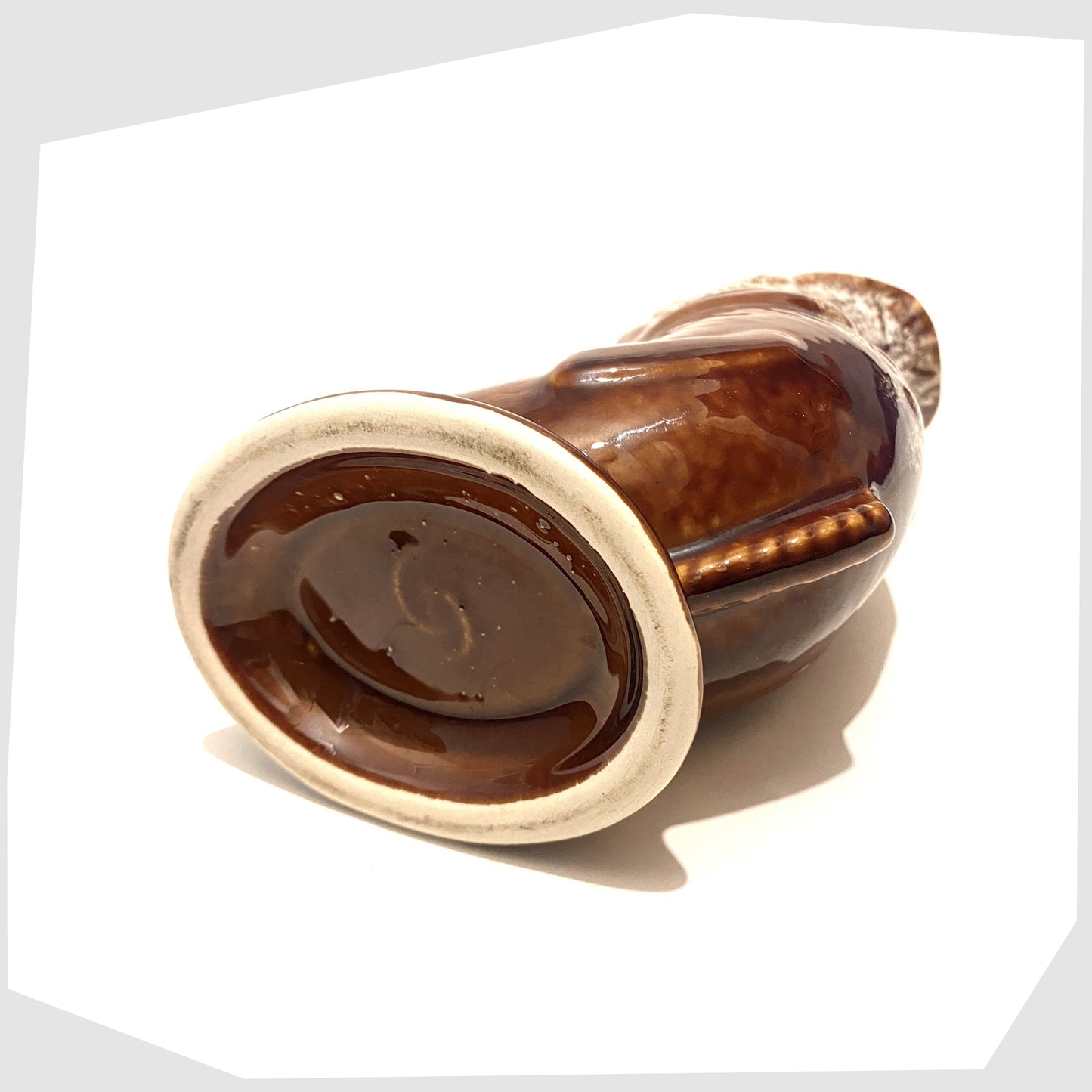 base stamp of the vintage studio pottery gluggle jug in brown glazing