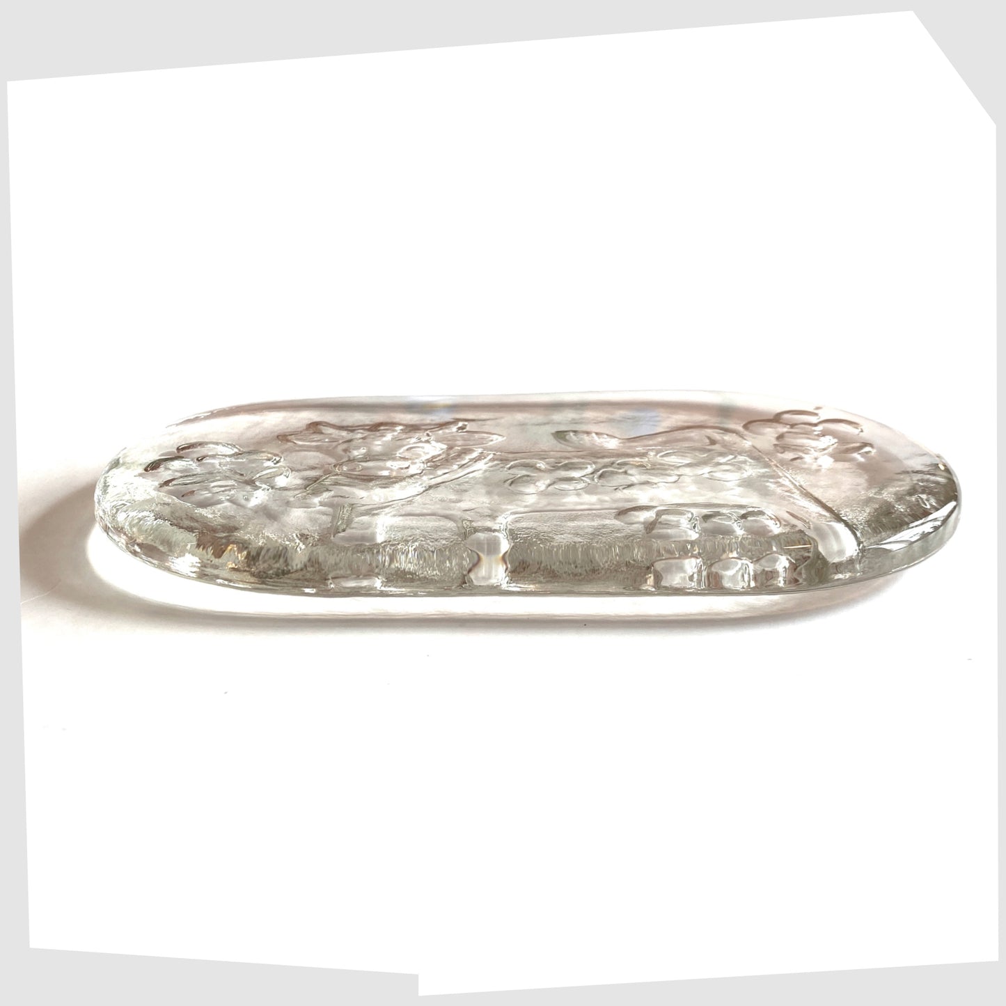 rear side of the Glasi Hergiswil Olma the cow dish, oval glass dish with a impressed cow design
