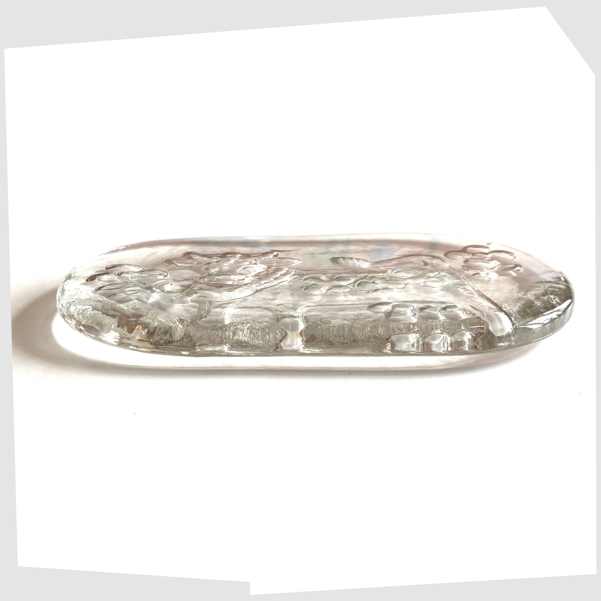 rear side of the Glasi Hergiswil Olma the cow dish, oval glass dish with a impressed cow design