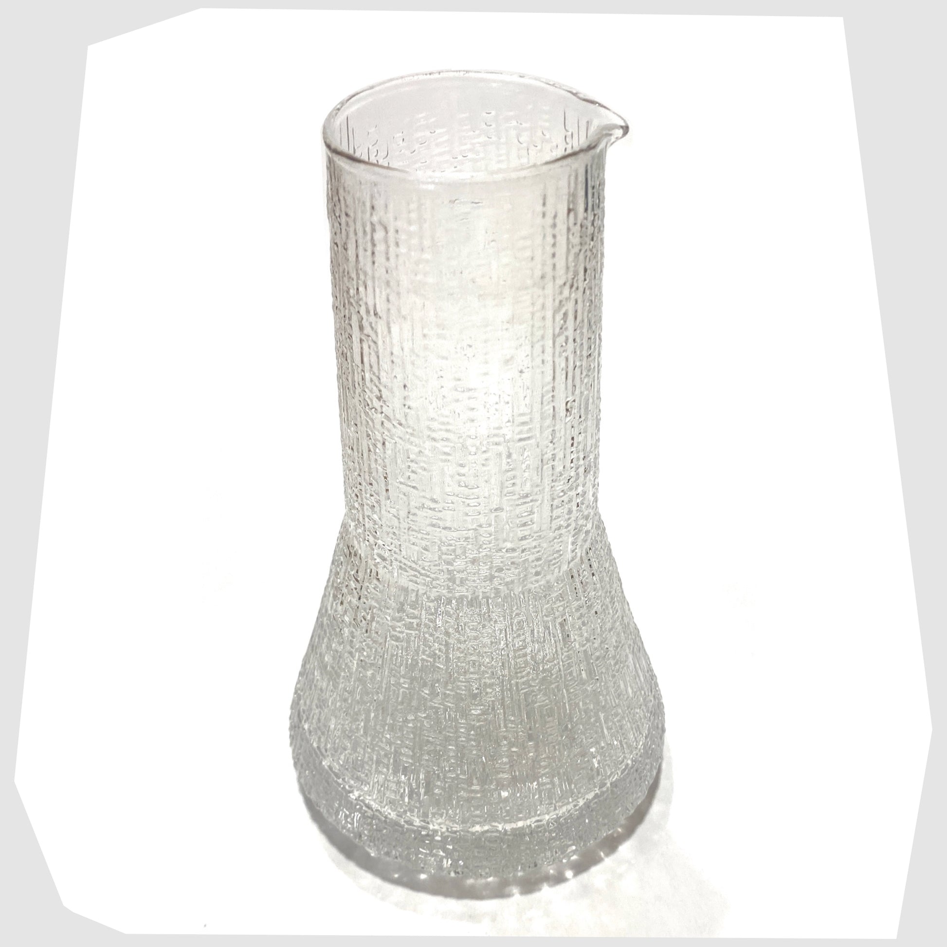 top rim of the Iittala Ultima Thule Glass Pitcher in clear glass with an ice textured finish, shown on a white background