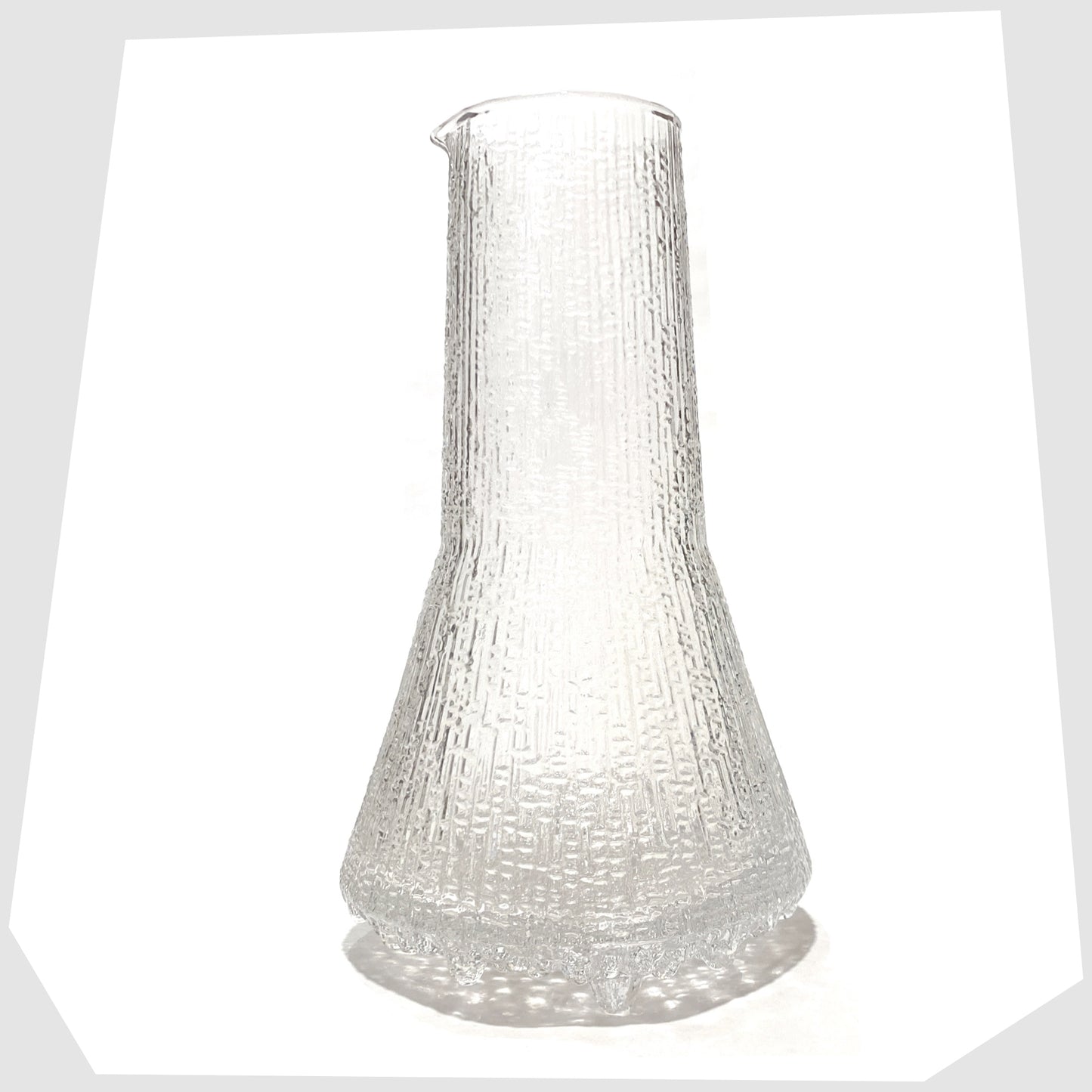 1960s Iittala Ultima Thule Glass Pitcher in clear glass with an ice textured finish, shown on a white background