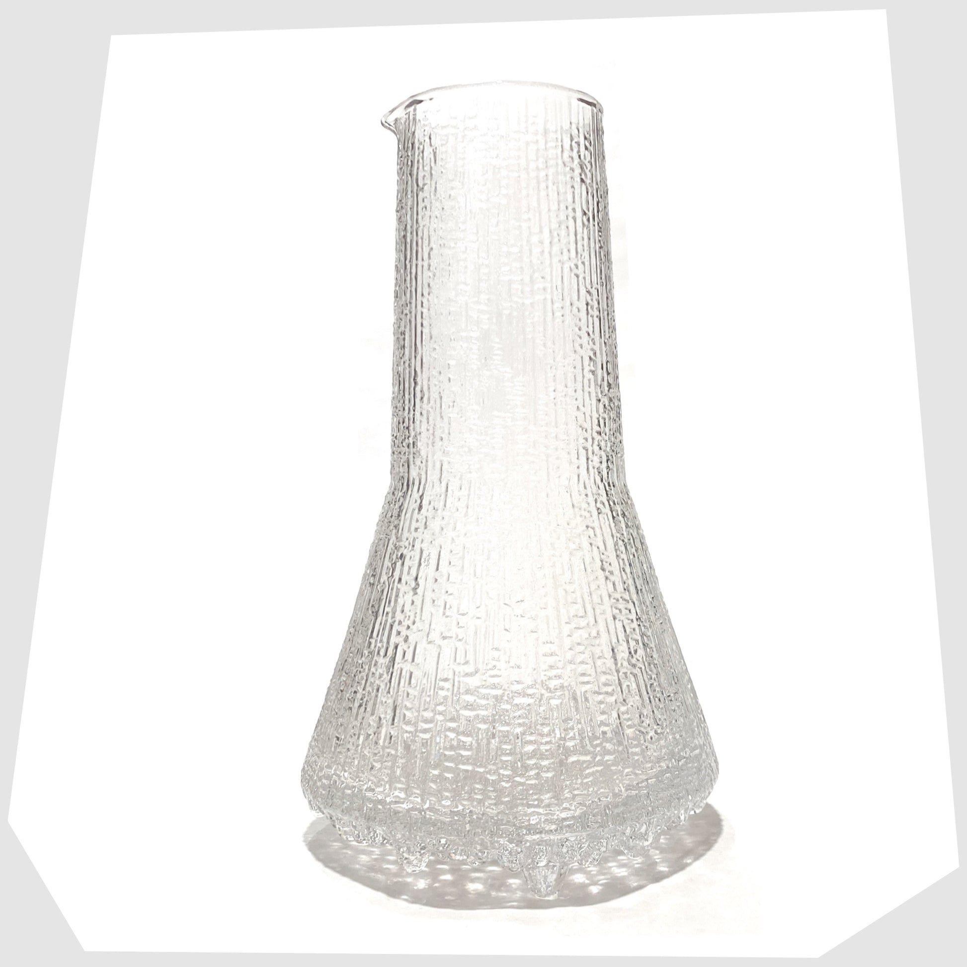 1960s Iittala Ultima Thule Glass Pitcher in clear glass with an ice textured finish, shown on a white background