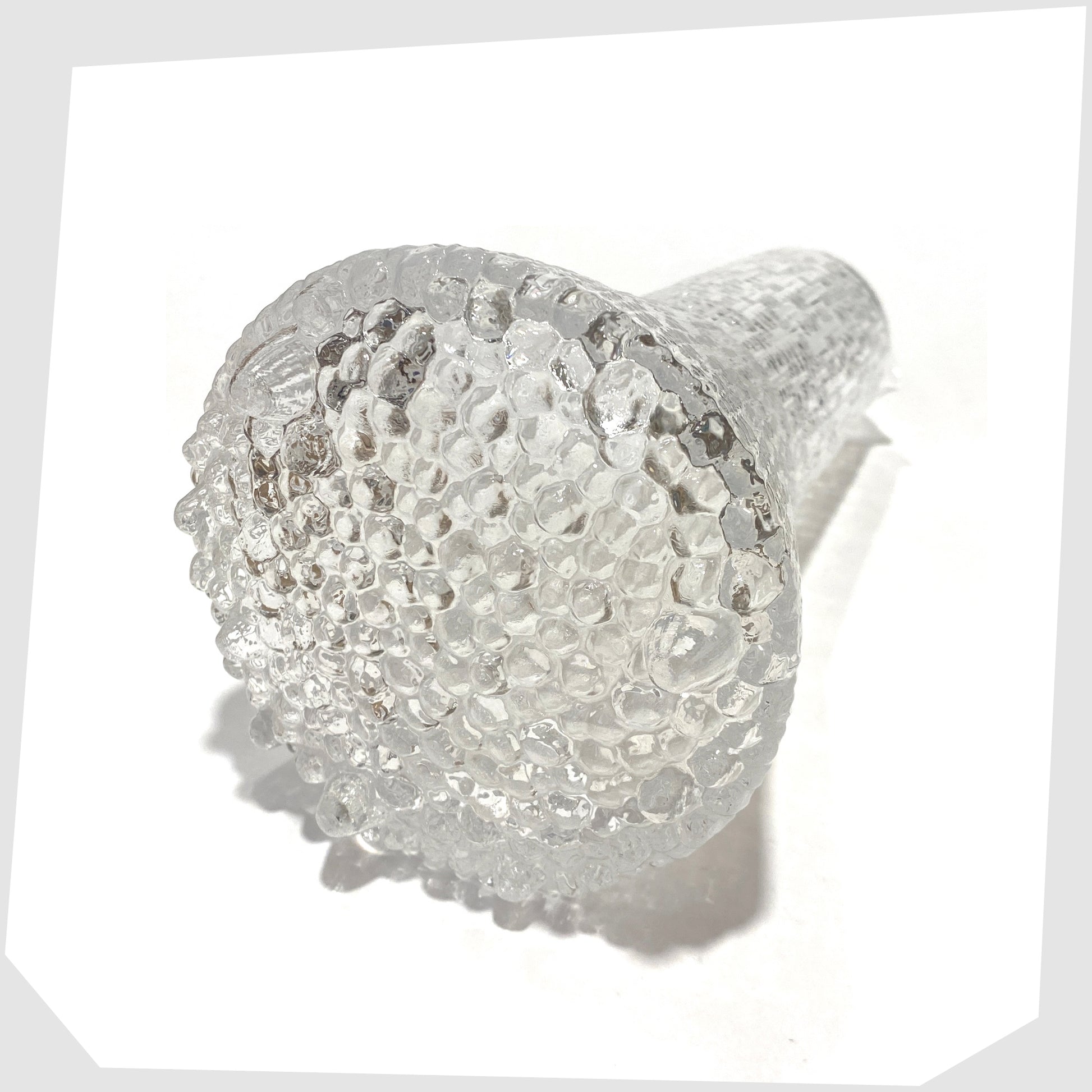 Base of the Iittala Ultima Thule Glass Pitcher in clear glass with an ice textured finish, shown on a white background