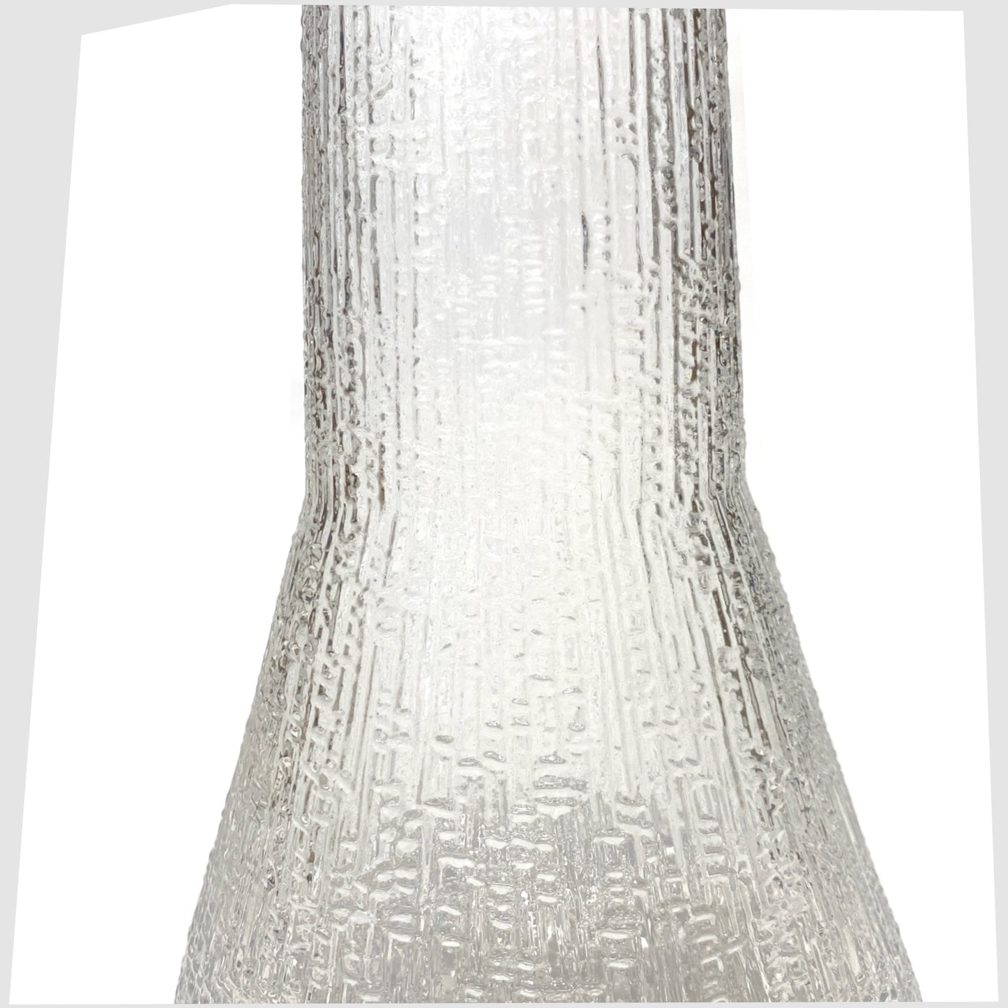 Mid-section of the Iittala Ultima Thule Glass Pitcher in clear glass with an ice textured finish, shown on a white background