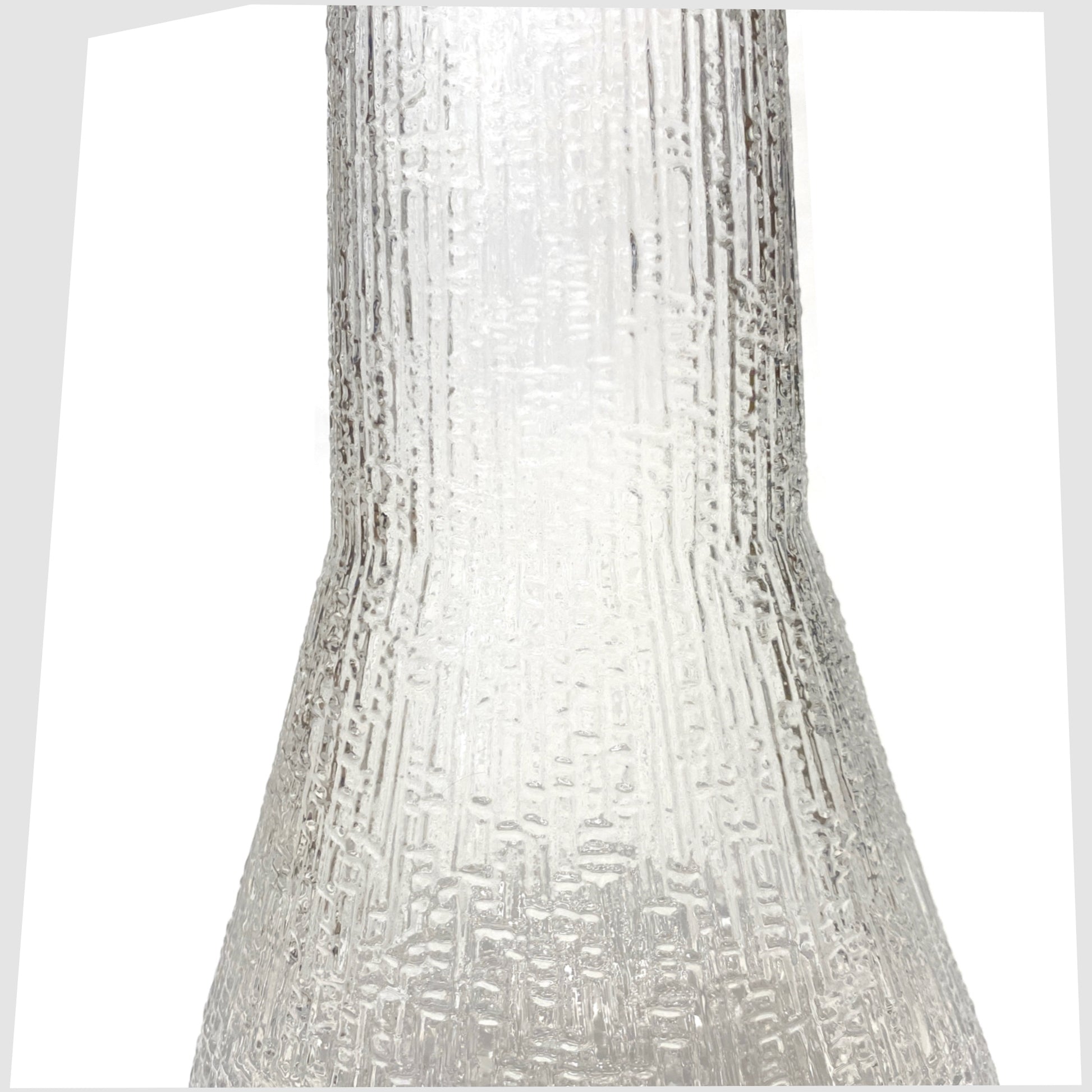 Mid-section of the Iittala Ultima Thule Glass Pitcher in clear glass with an ice textured finish, shown on a white background
