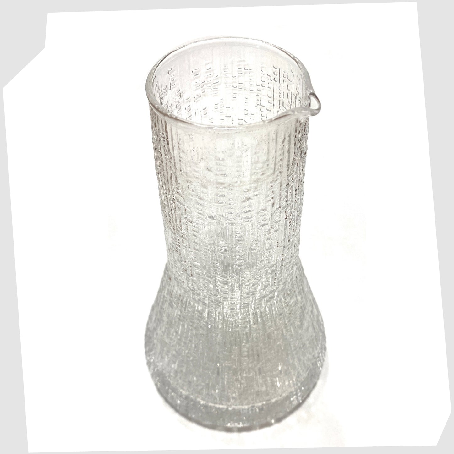 Spout of the Iittala Ultima Thule Glass Pitcher in clear glass with an ice textured finish, shown on a white background