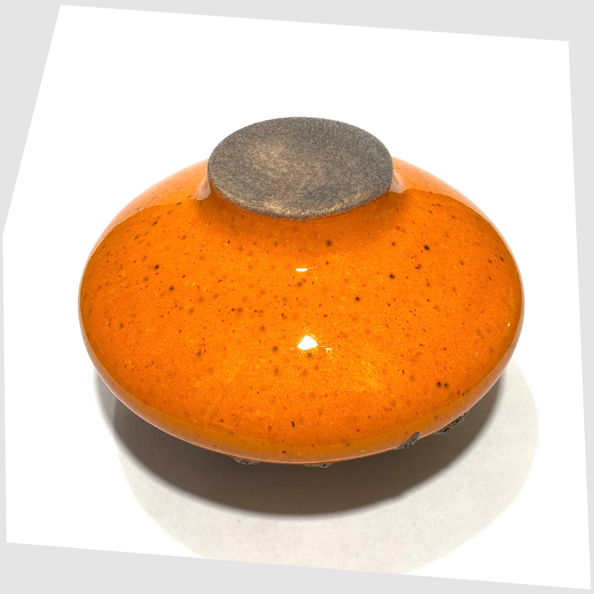 Felted base of the Otto Keramik Vase, model 203, in a vibrant orange glaze with grey fat lava, shown on a white background