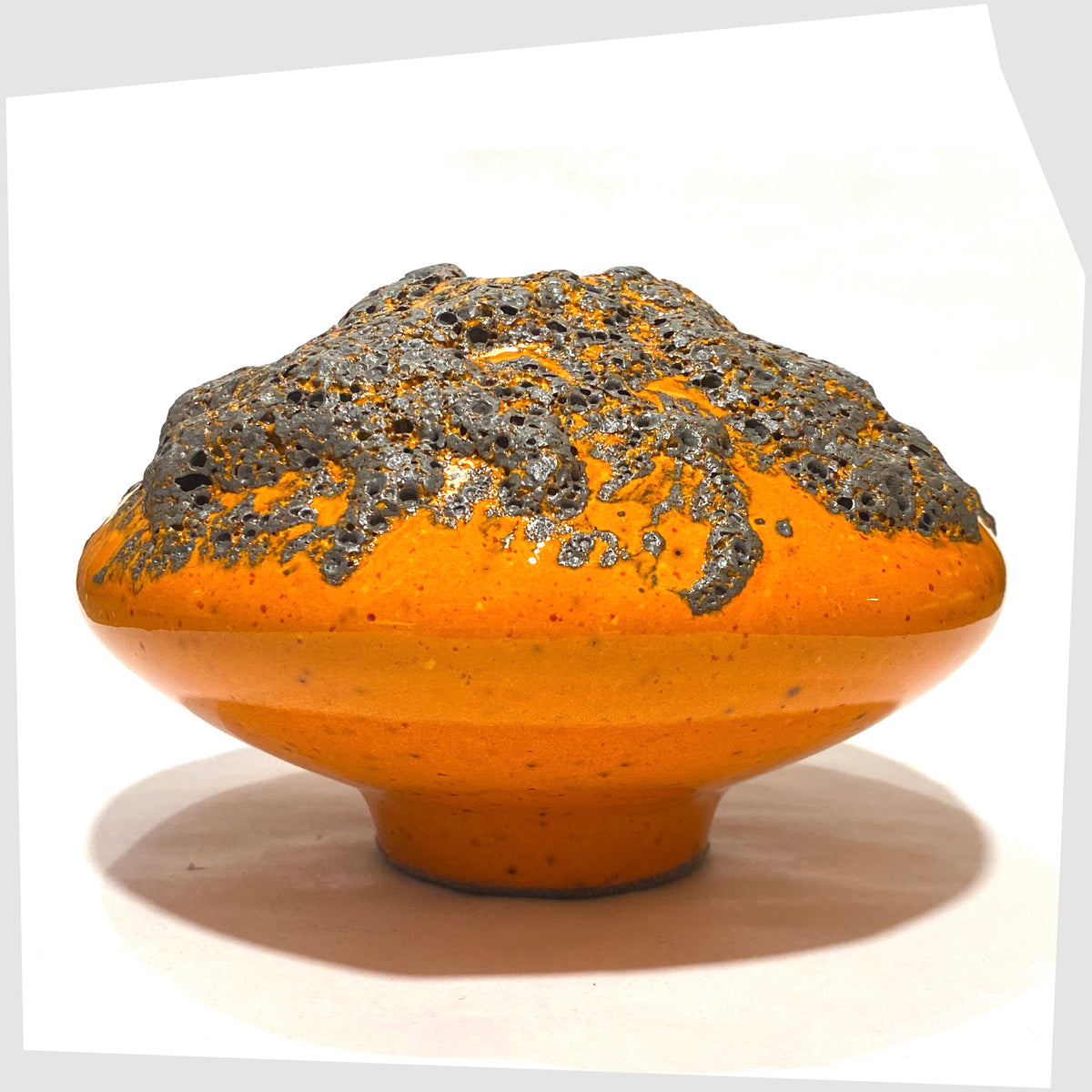 Otto Keramik UFO-shaped Vase, model 203, in a vibrant orange glaze with grey fat lava, shown on a white background