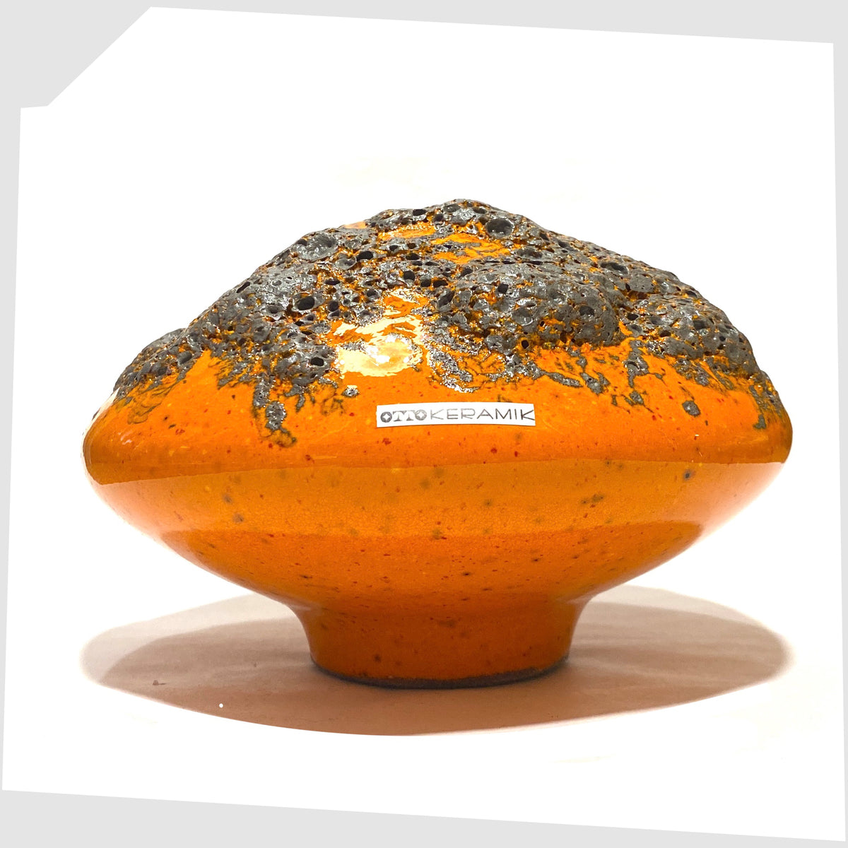 Otto Keramik Vase, model 203, in a vibrant orange glaze with grey fat lava ans original sticker attached, shown on a white background