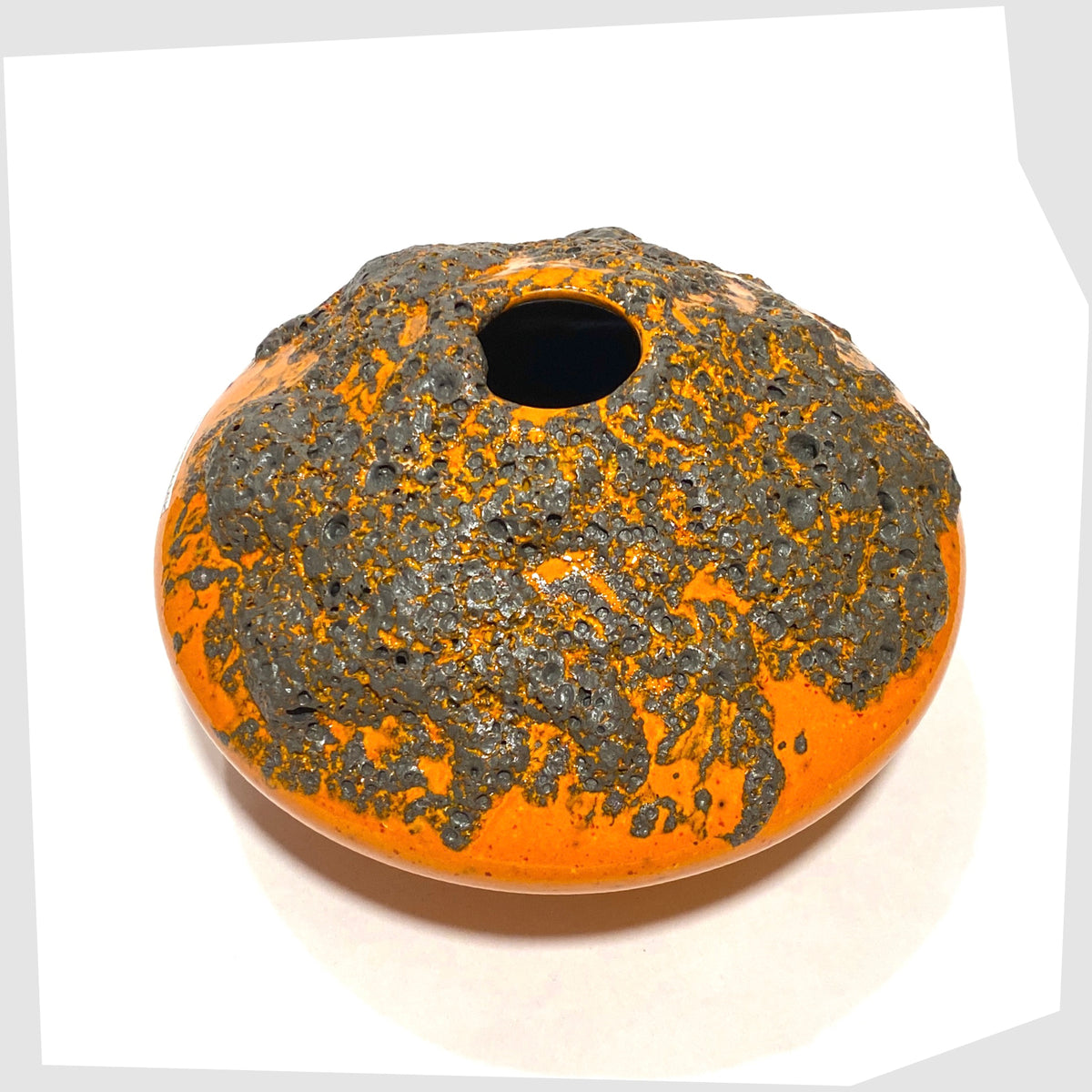 Overhead view of the Otto Keramik Vase, model 203, in a vibrant orange glaze with grey fat lava, shown on a white background