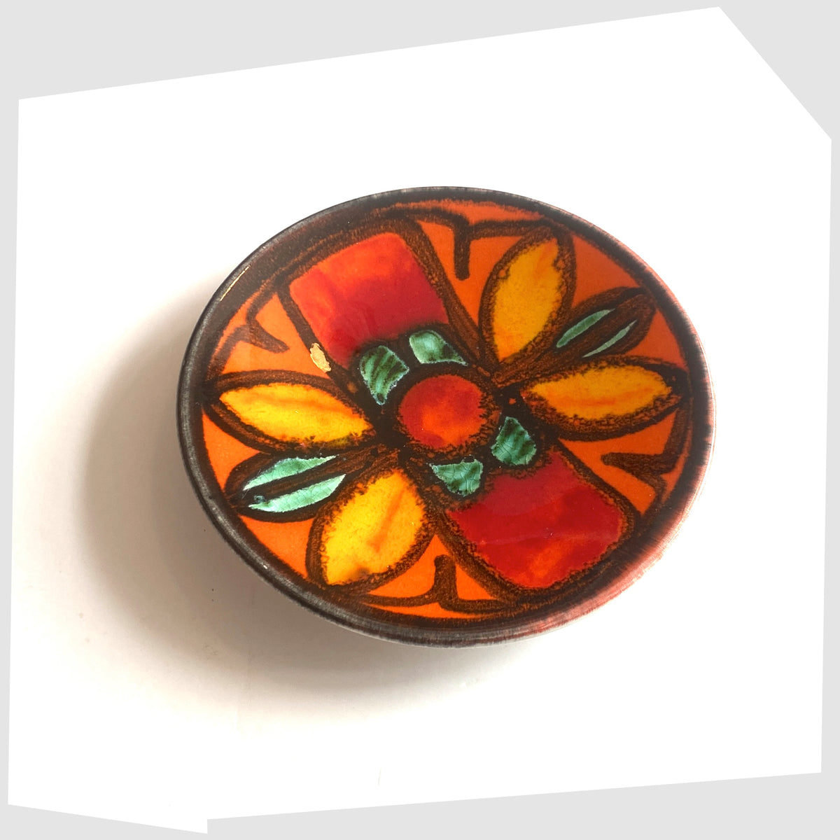Poole Pottery Delphis Pin Dish, shape 49, by Janet Parker-Laird glazed in a vivid orange with fluid forms of green and yellow glaze- Shown on a white background