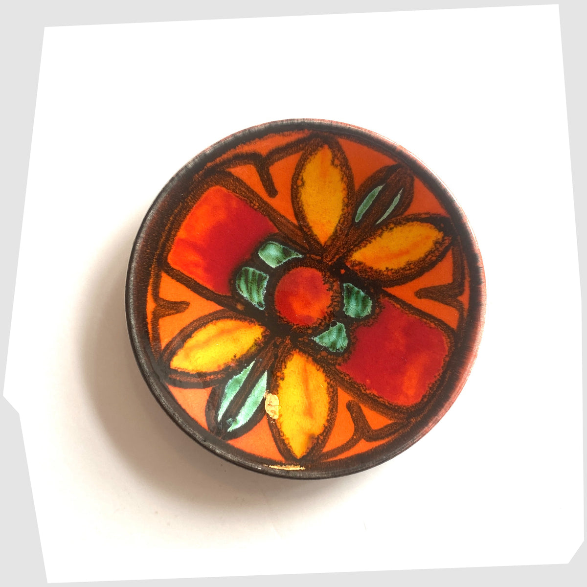 Poole Pottery Delphis Pin Dish, shape 49, by Janet Laird glazed in a vivid orange with fluid forms of green and yellow glaze- Shown on a white background