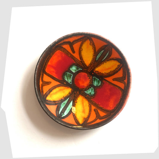 Poole Pottery Delphis Pin Dish, shape 49, by Janet Laird glazed in a vivid orange with fluid forms of green and yellow glaze- Shown on a white background