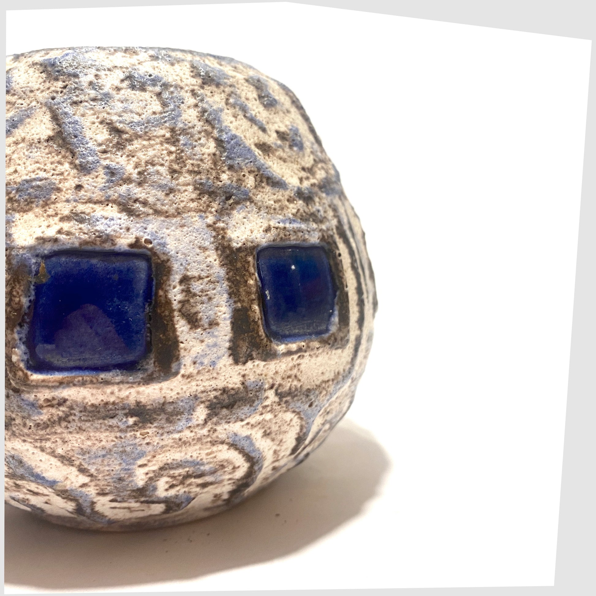 close up of the Schlossberg Keramik 259 spherical vase in white fat lava glaze with blue squares