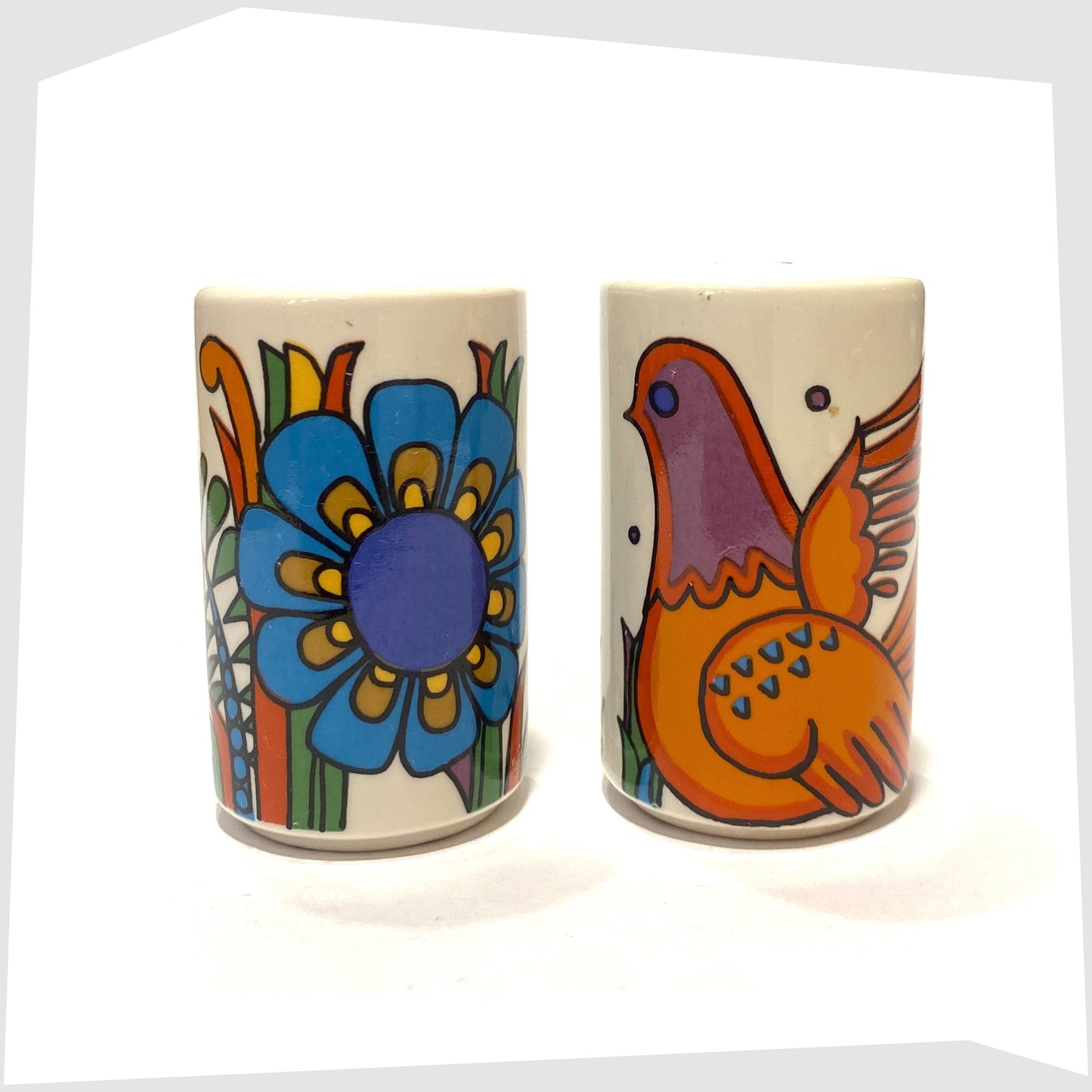 Villeroy and Boch Acapulco Salt & Pepper Shakers showing the full wrap around design of blue flowers and orange bird, shown on a white background