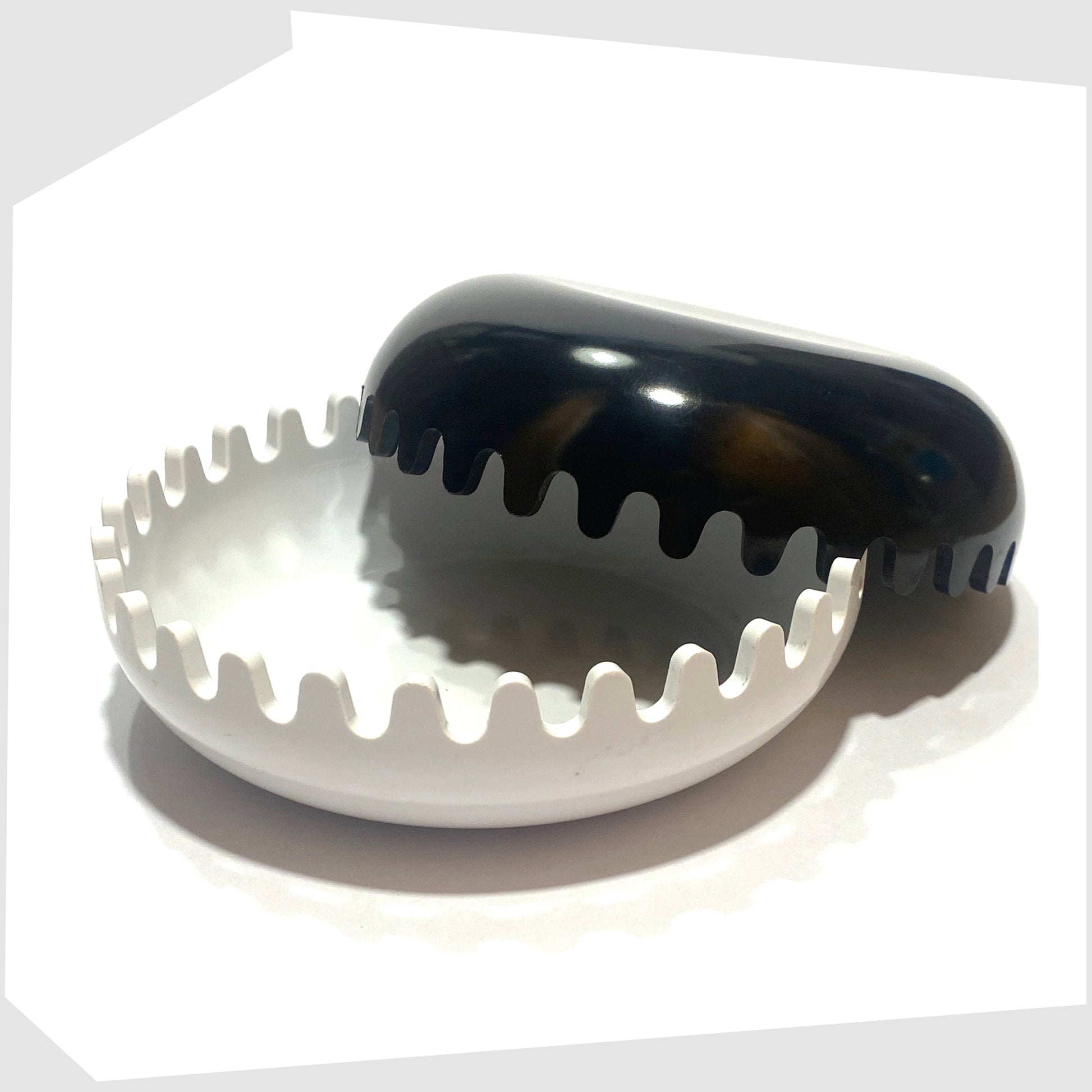 open clam ashtray designed by alan fletcher in black and white