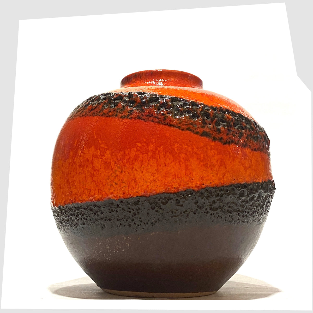Bay Keramik 64-12 vase with volcanic red and orange glaze with bands of black fat lava, shown on a white background