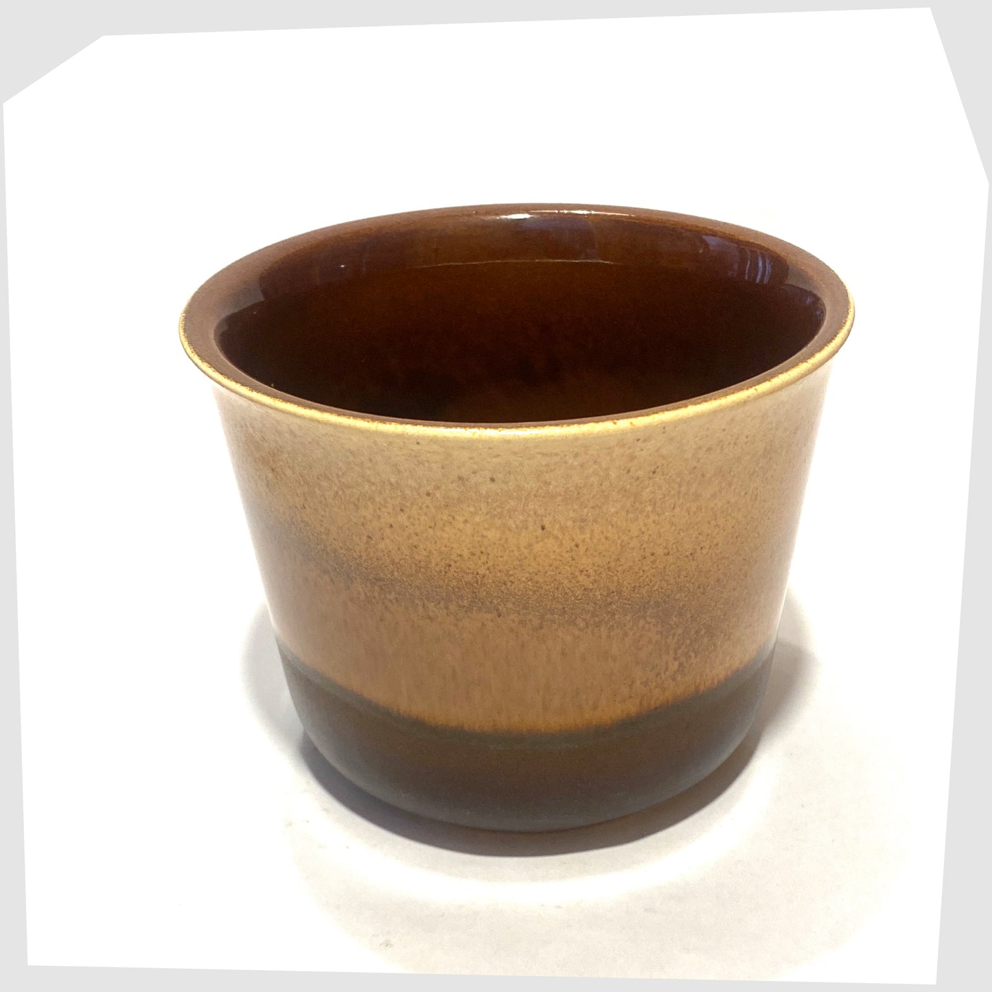 Top rim of the 1970s Bay Keramik 653-14 Planter in amber and brown glaze, shown on a white background