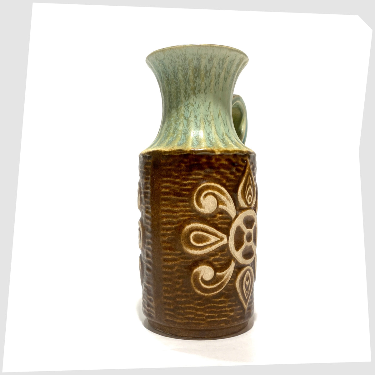 1970s Bay Keramik 69-20 Vase with a radiating relief design and complimenting green glaze, shown on a white background