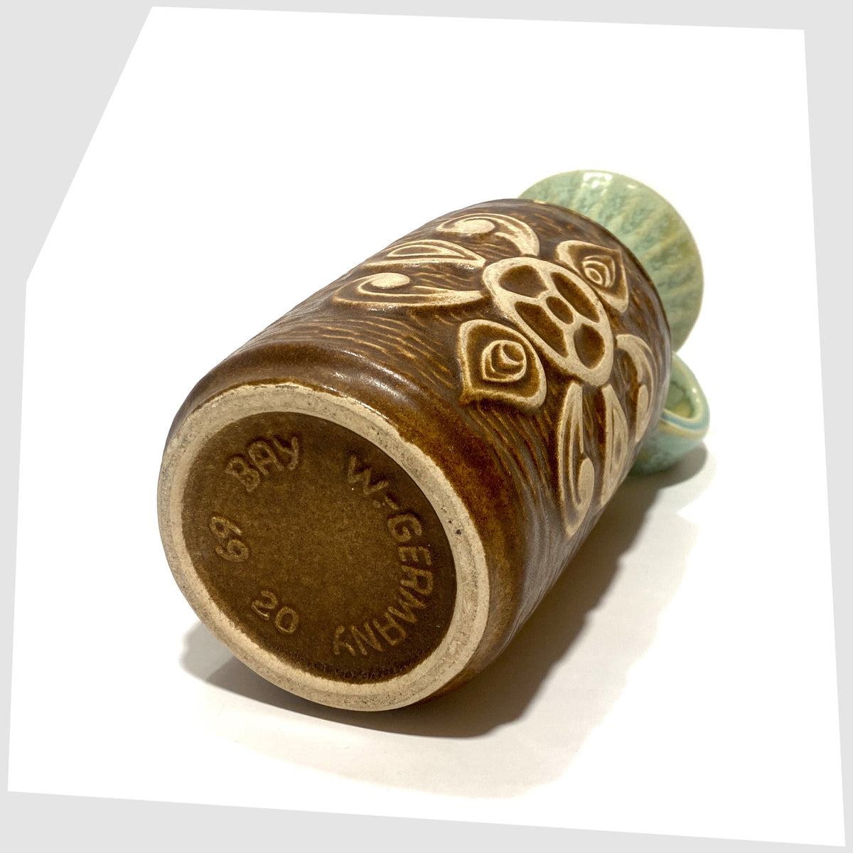 Base of the Bay Keramik 69-20 Vase with a radiating relief design and complimenting green glaze, shown on a white background