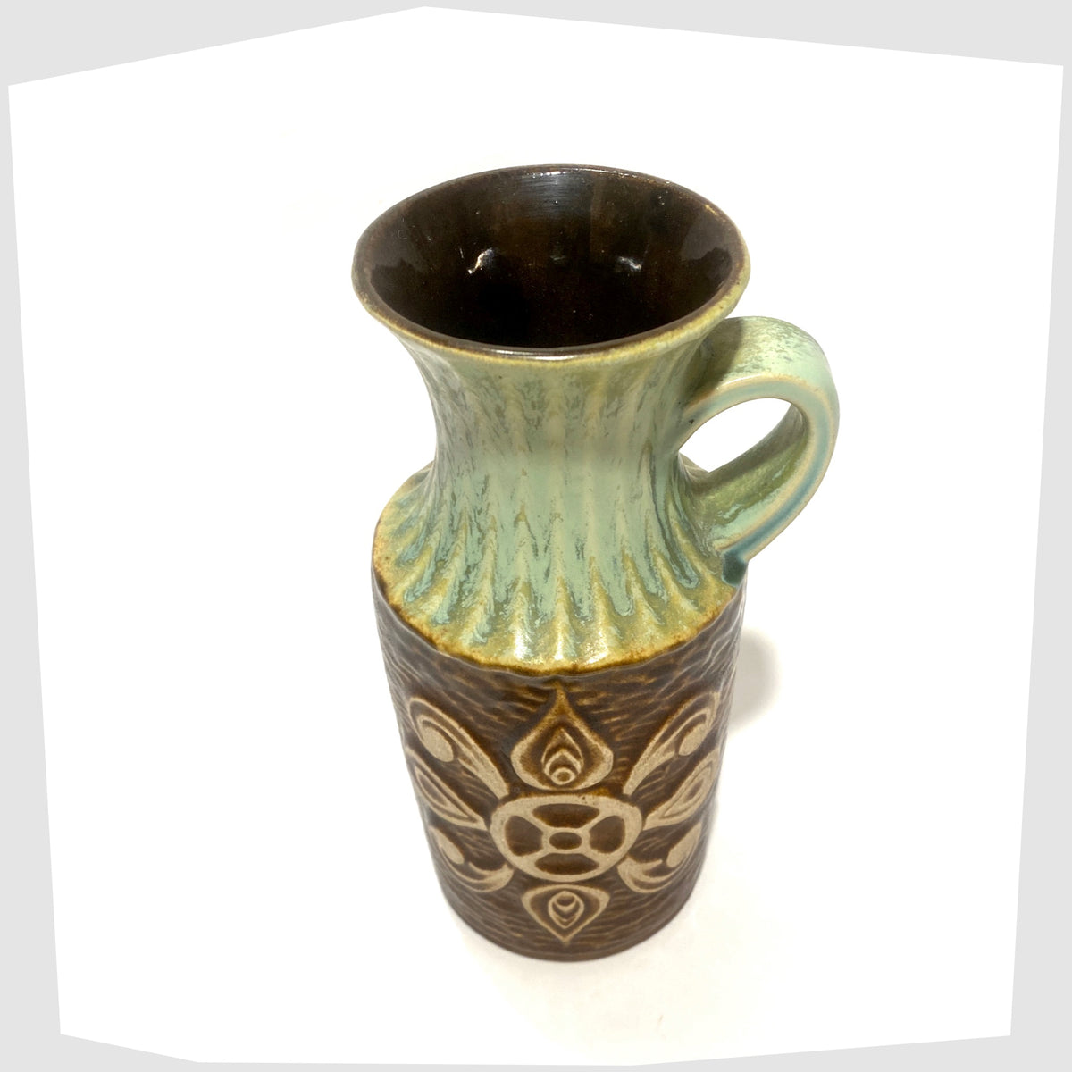 Top rim of the Bay Keramik 69-20 Vase with a radiating relief design and complimenting green glaze, shown on a white background