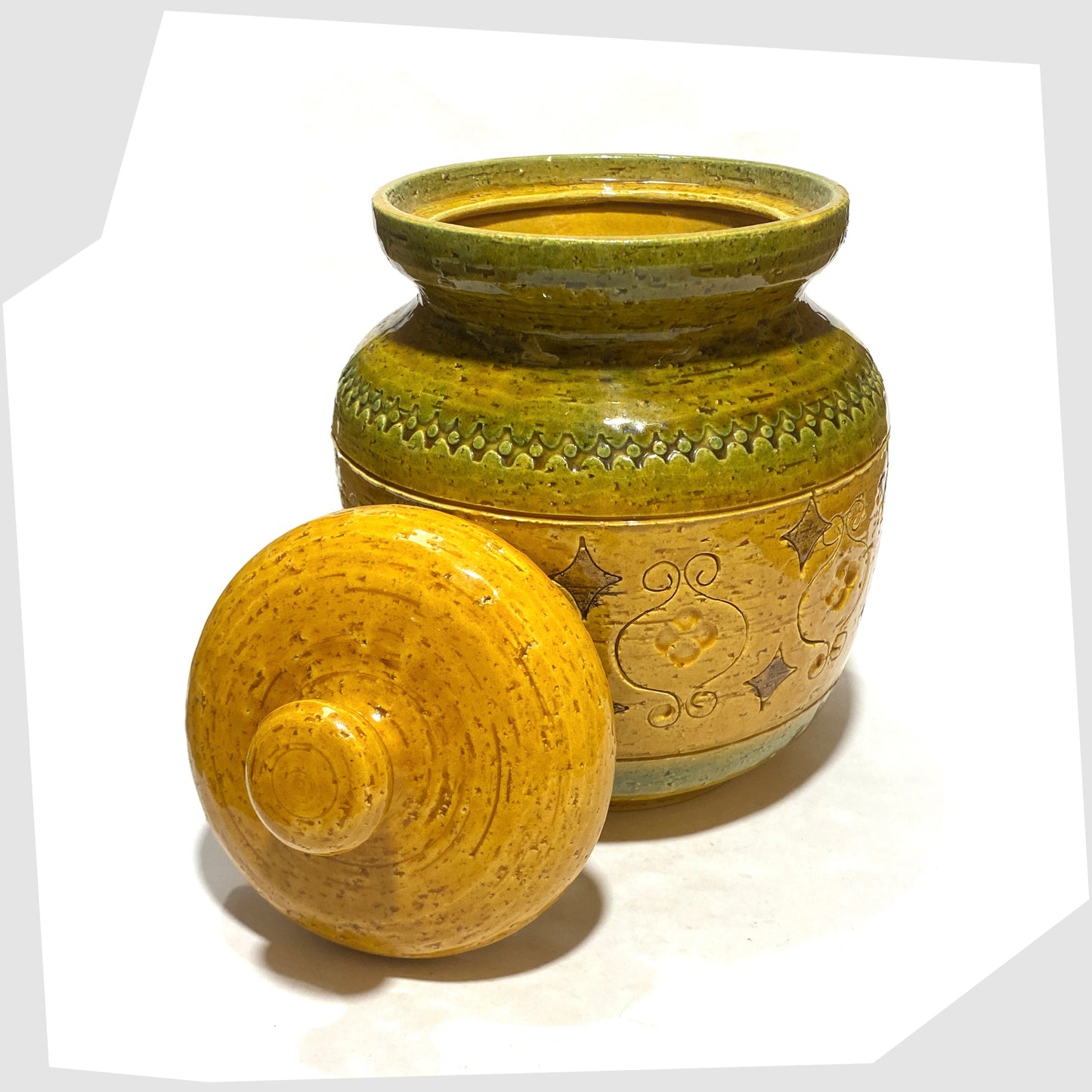 Bitossi Arabesque Lidded Jar in yellow glaze with green bands and impressed markings, shown with its lid off, on a white background