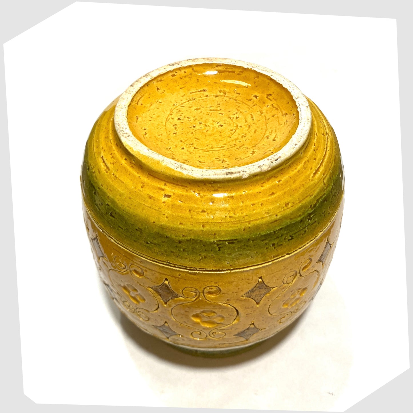 Underneath of the Bitossi Arabesque Lidded Jar in yellow glaze with green bands and impressed markings, shown on a white background